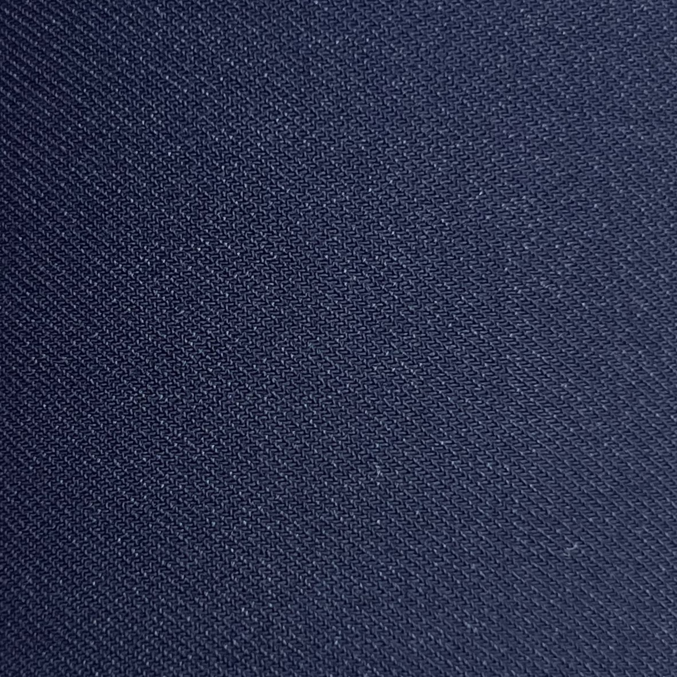 Close-up of navy blue virgin wool and silk suiting fabric with a fine, textured weave.