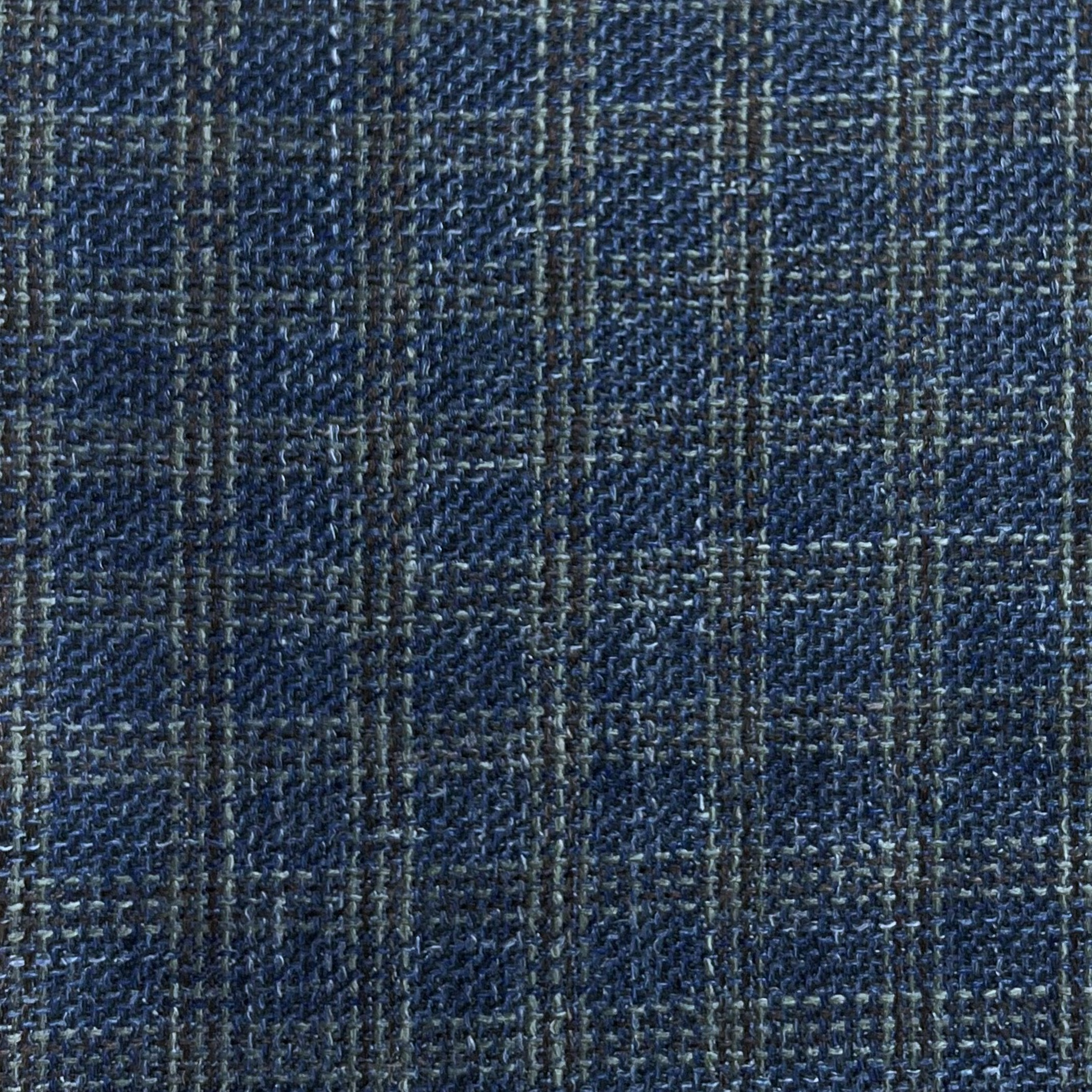 Close-up of dark blue virgin wool and silk tweed fabric with a subtle brown and grey plaid pattern.