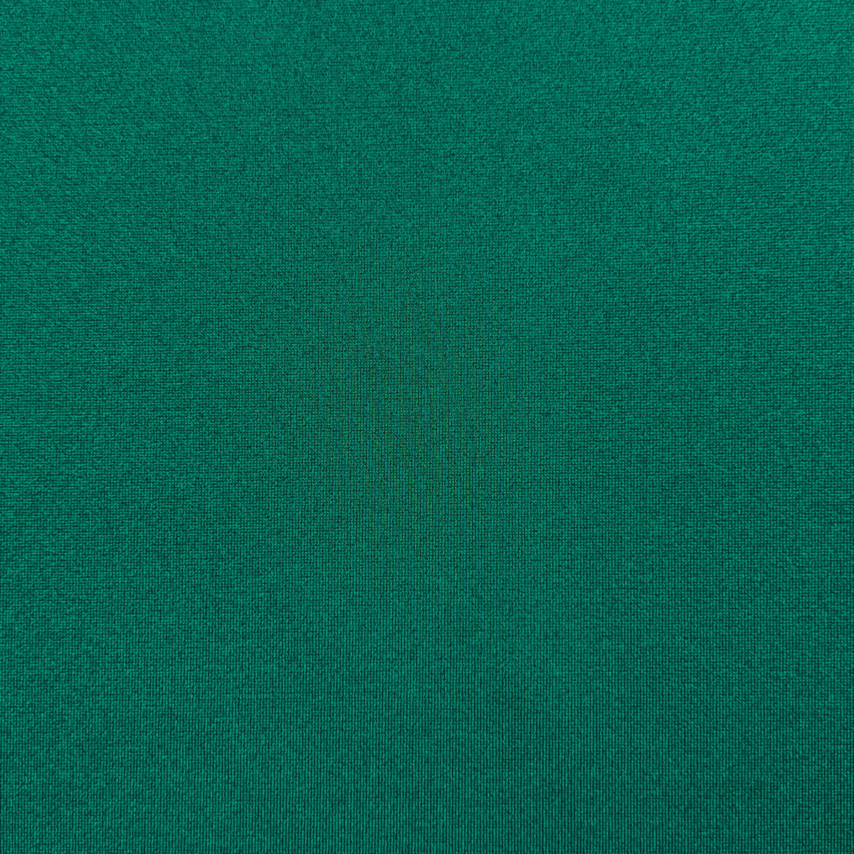 A close-up of a solid dark teal green textured fabric surface.