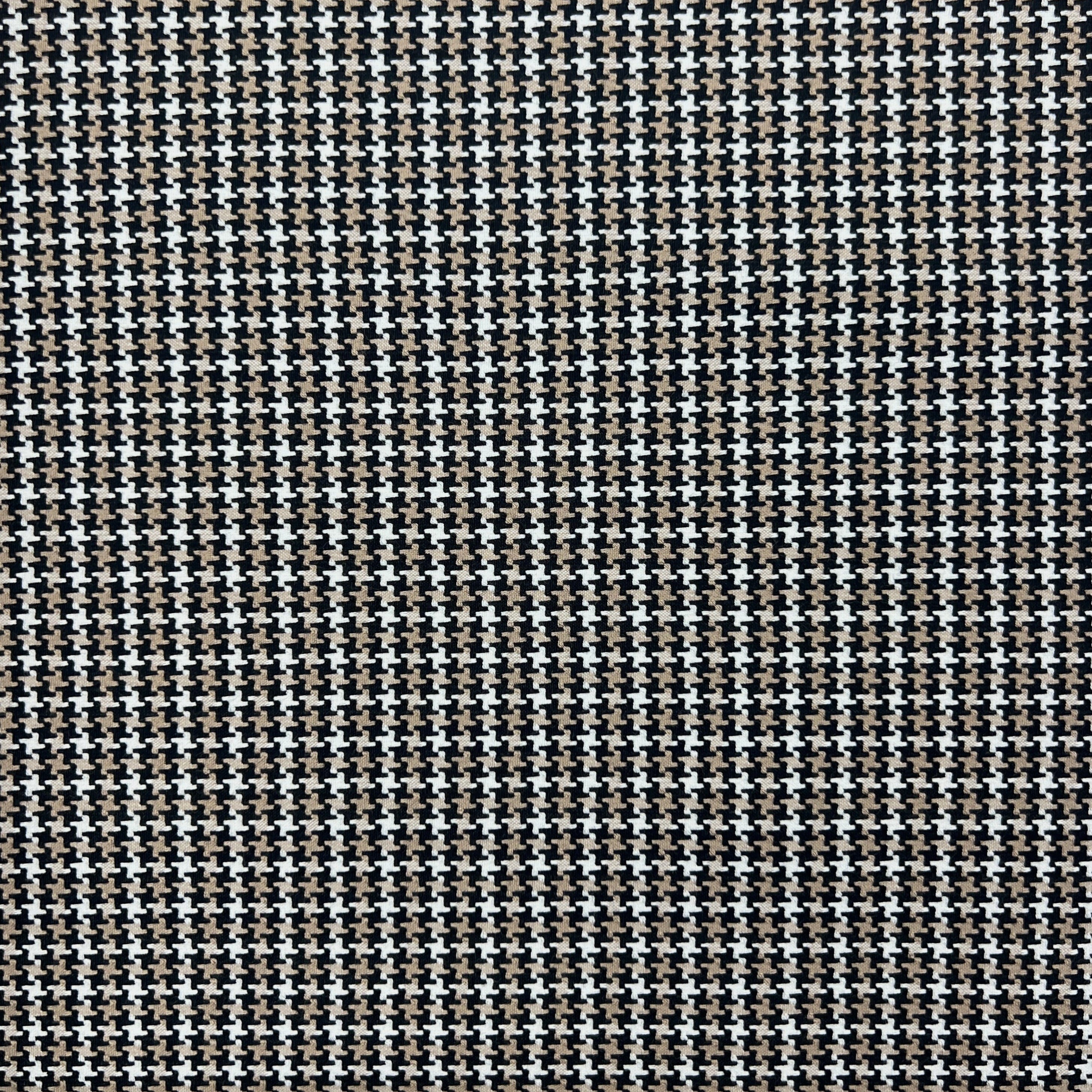 A close-up of a black and white houndstooth fabric pattern filling the entire frame.