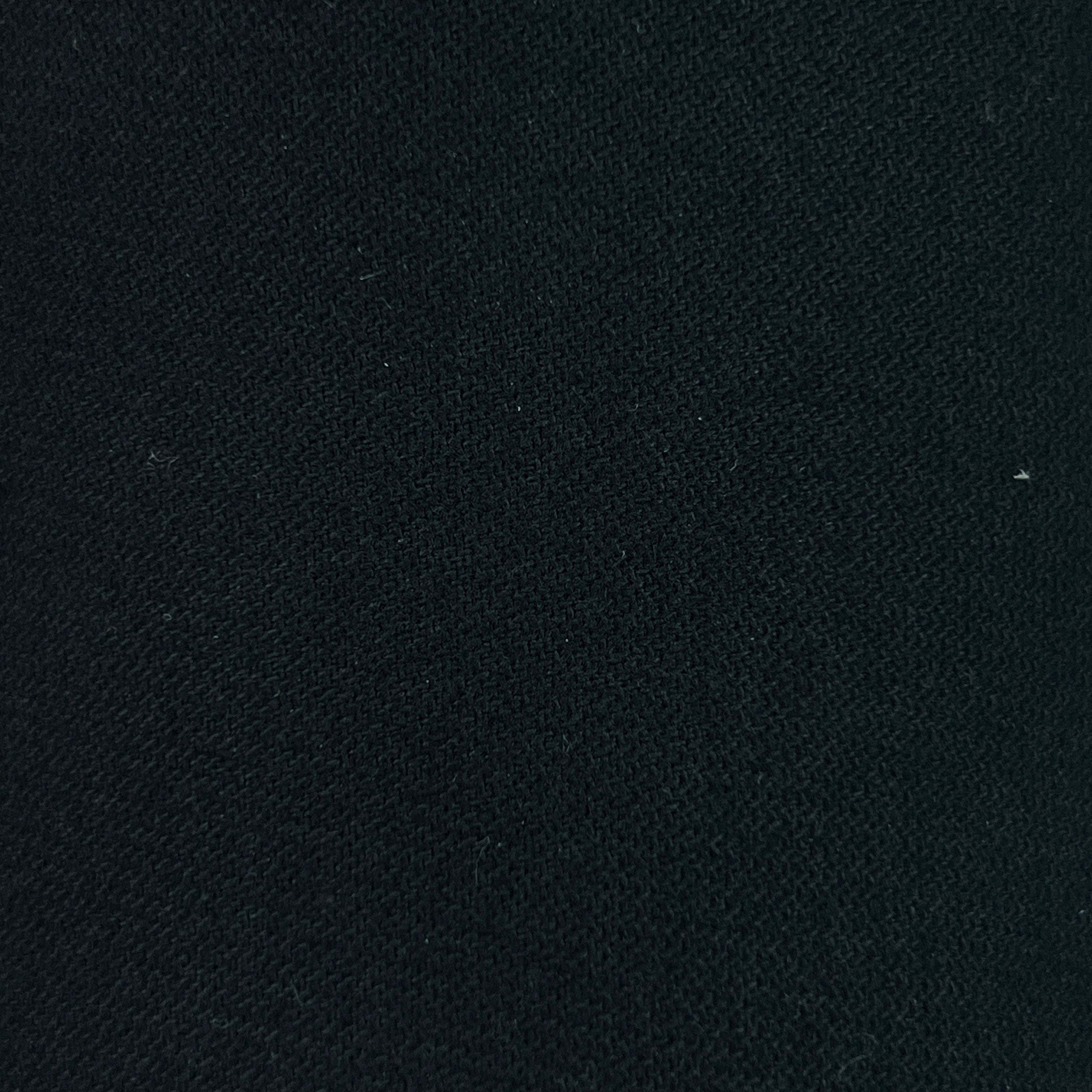 A close-up of a dark navy blue textured fabric, showing a fine woven pattern.