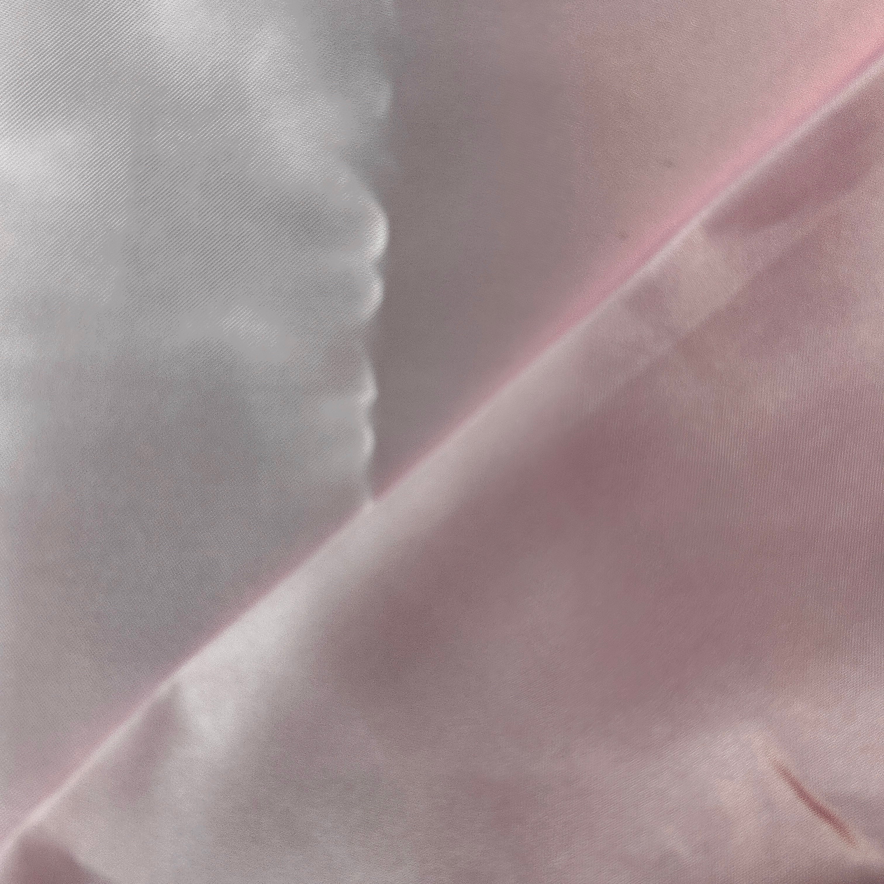 Close-up of light pink fabric with a subtle texture