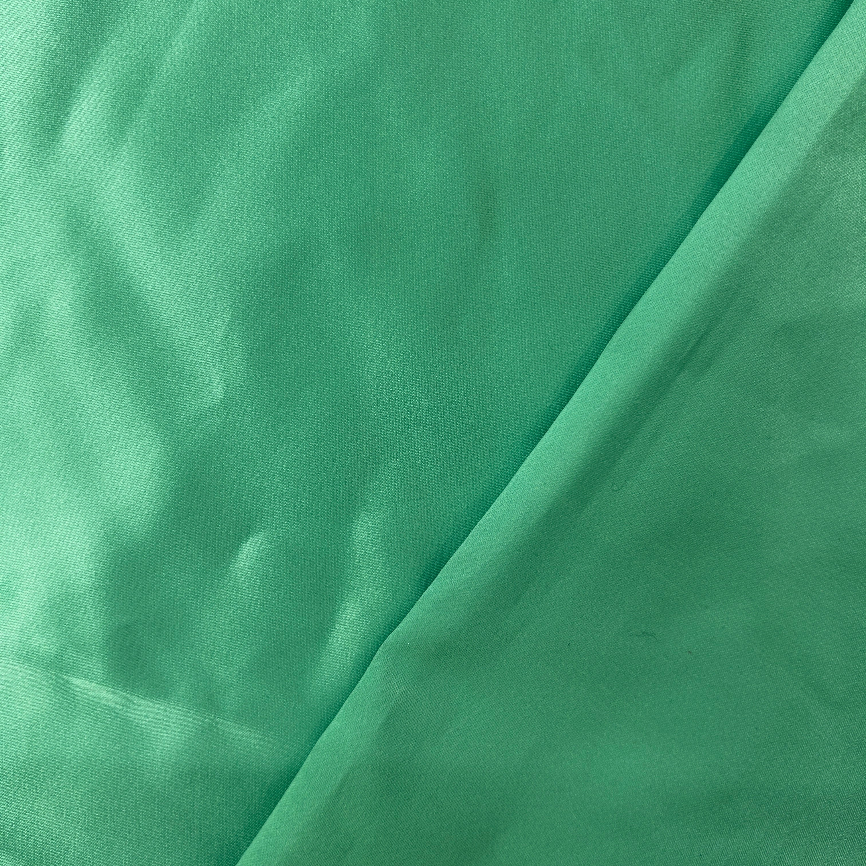 Close-up of green fabric with folds