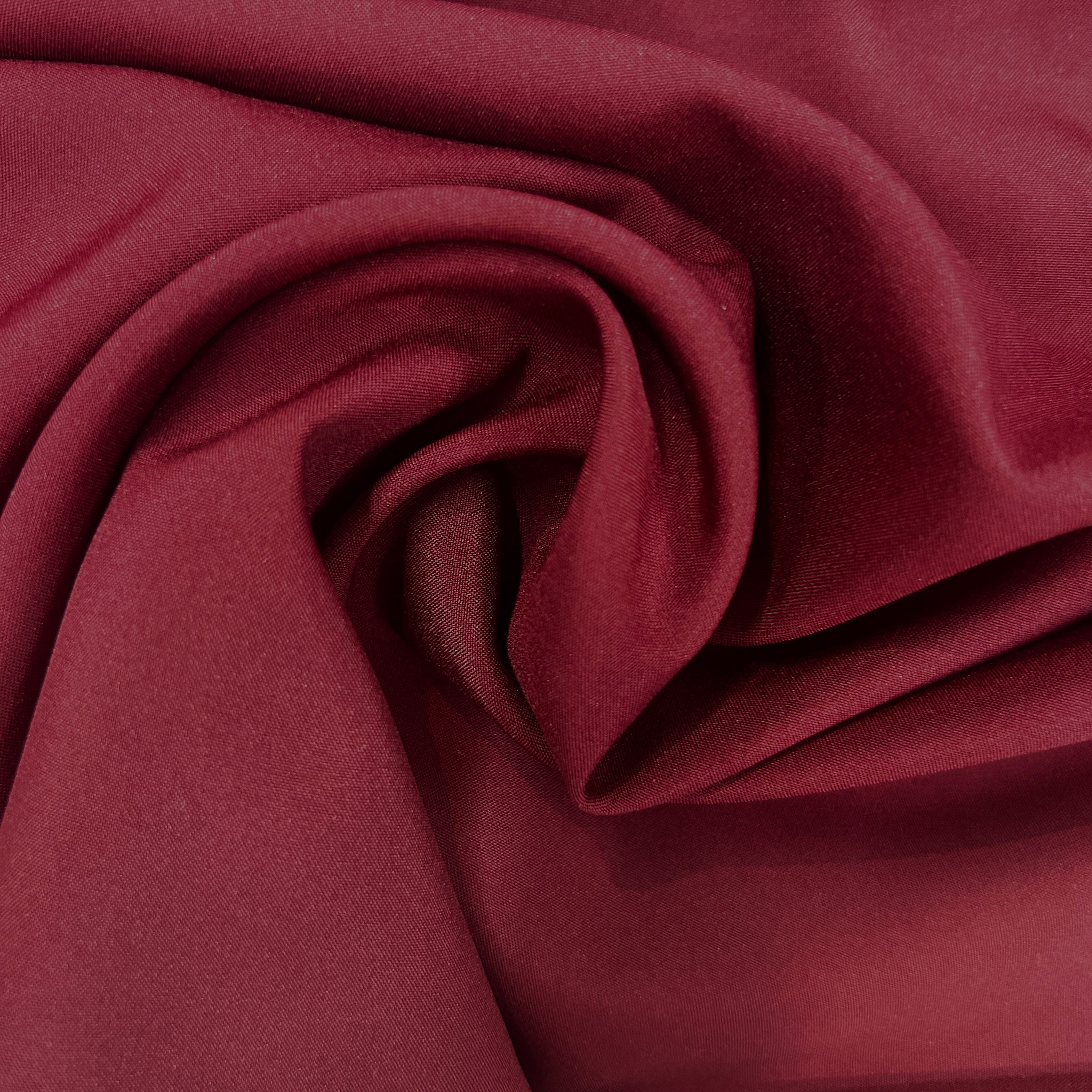 Close-up of maroon fabric with folds