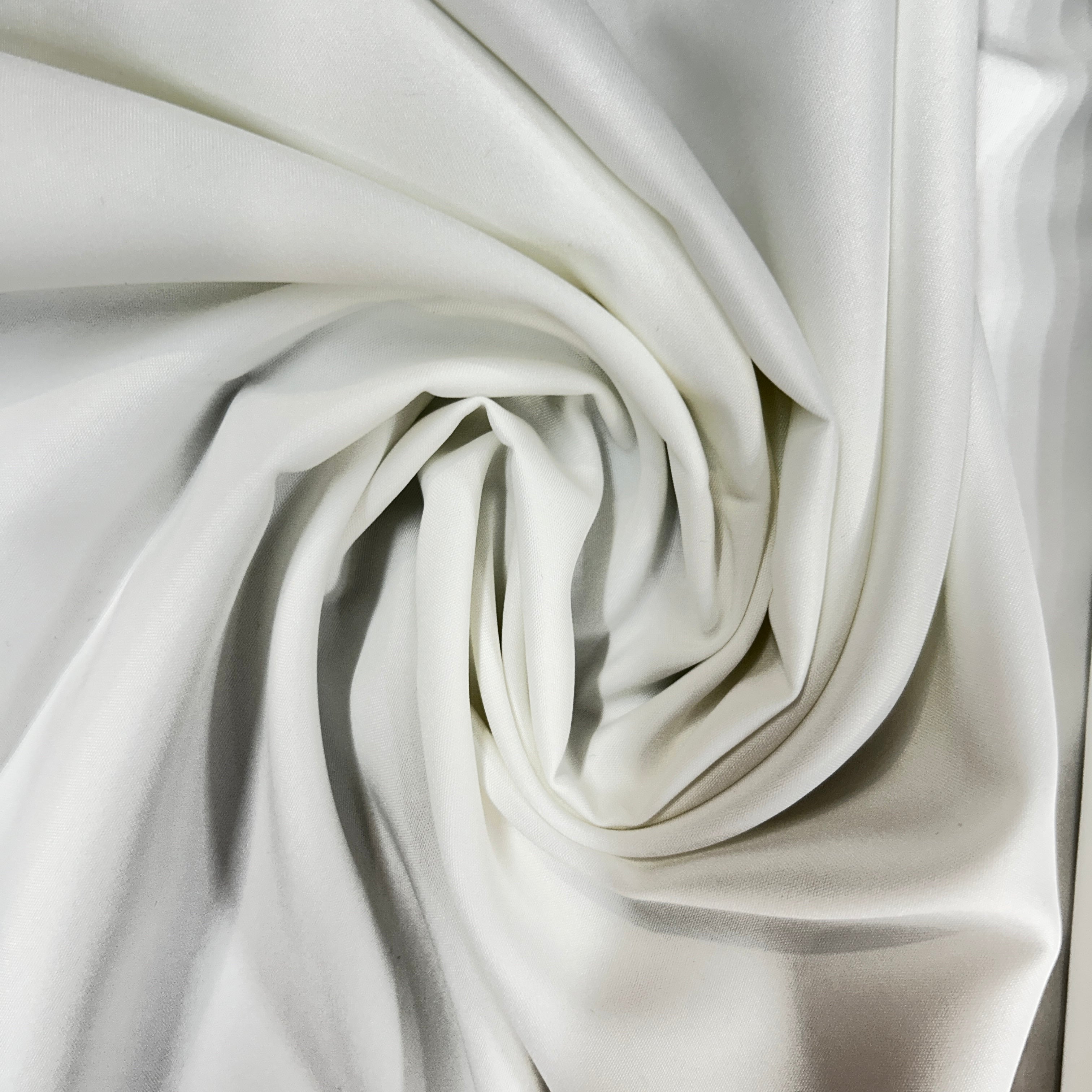 Cream mechanical stretch polyester fabric swirled to show drape and smooth texture.