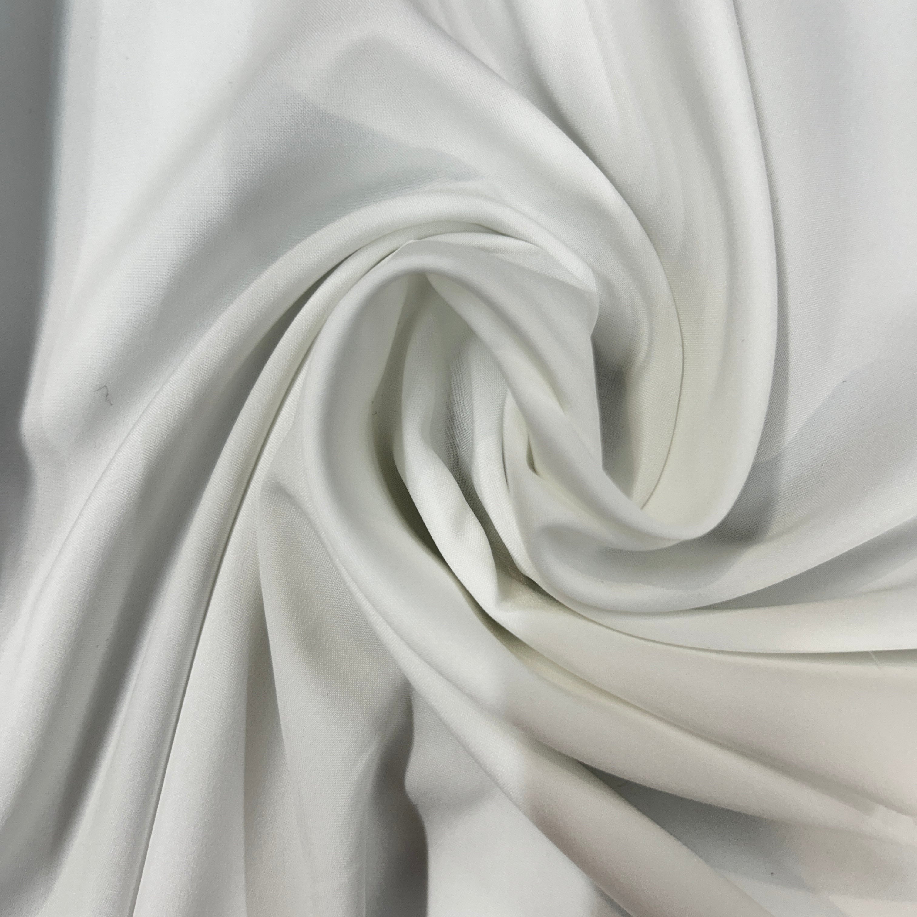 White mechanical stretch polyester fabric swirled to show its smooth texture and drape.