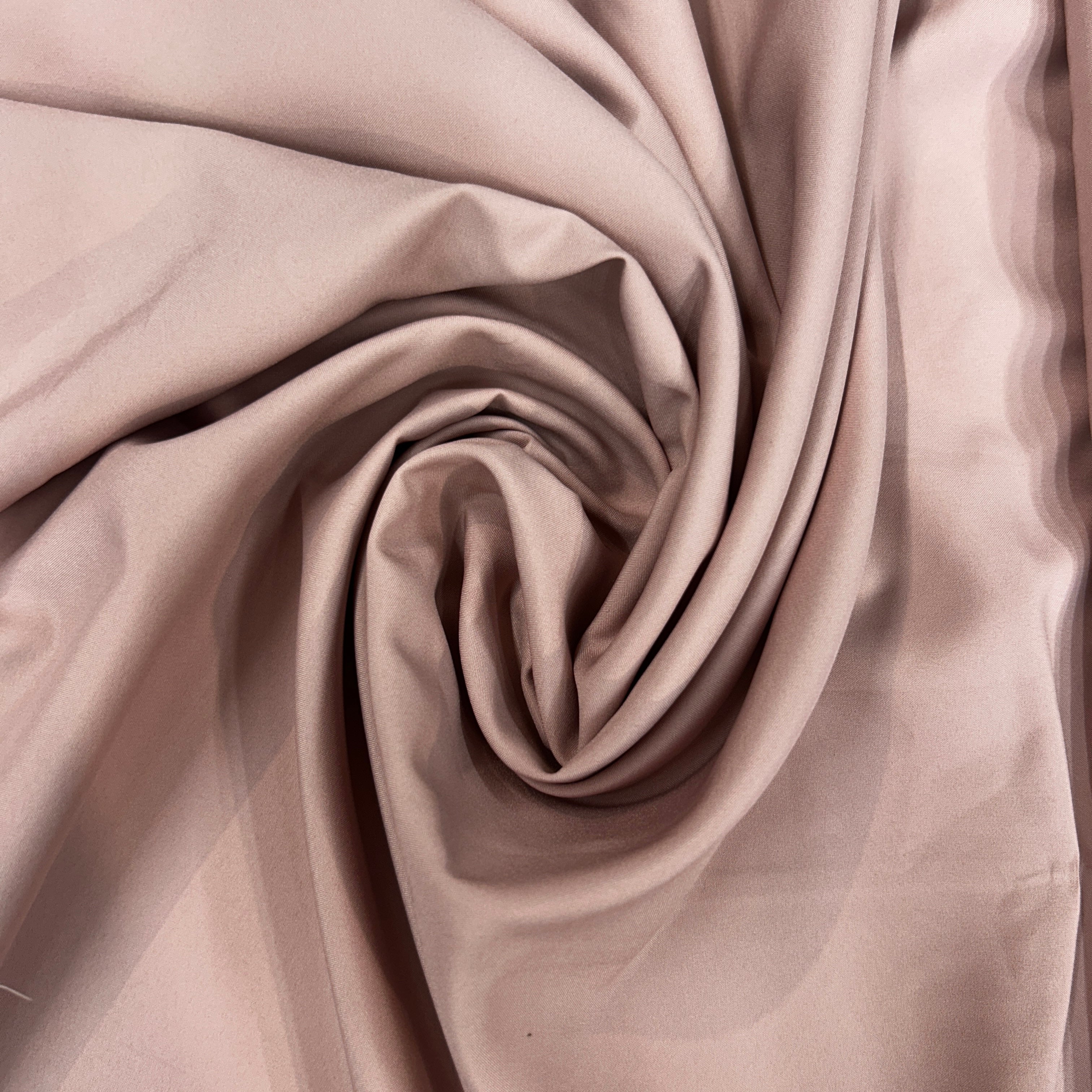 Swirled peach mechanical stretch polyester fabric with a smooth, draped texture.
