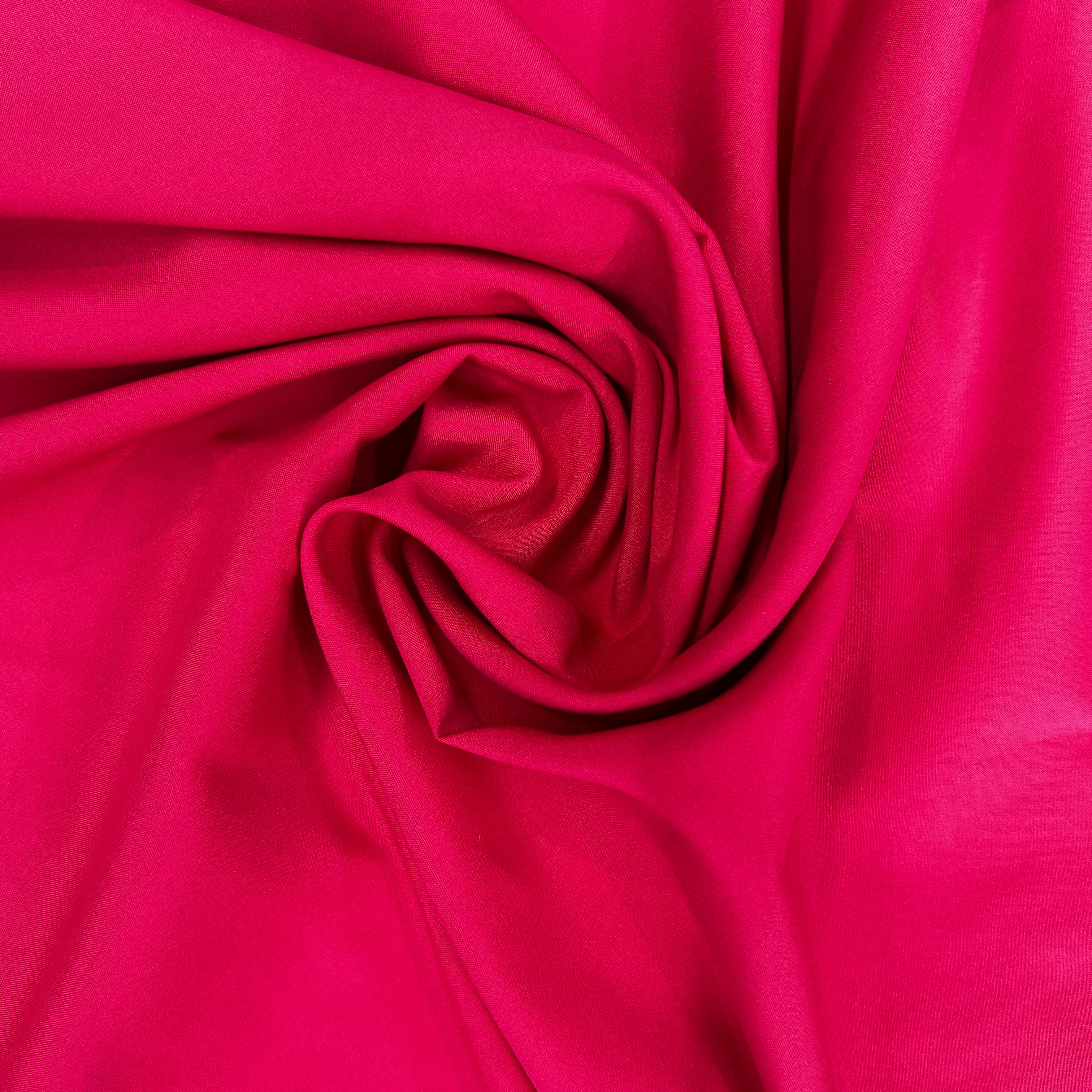 Swirled red mechanical stretch polyester fabric with a smooth, matte finish.