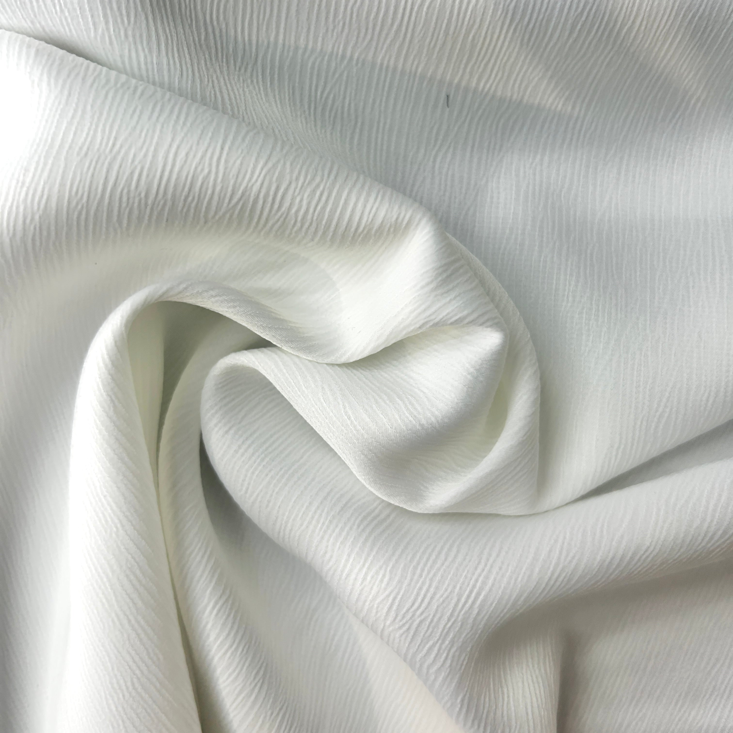 Close-up of white fabric with a subtle texture