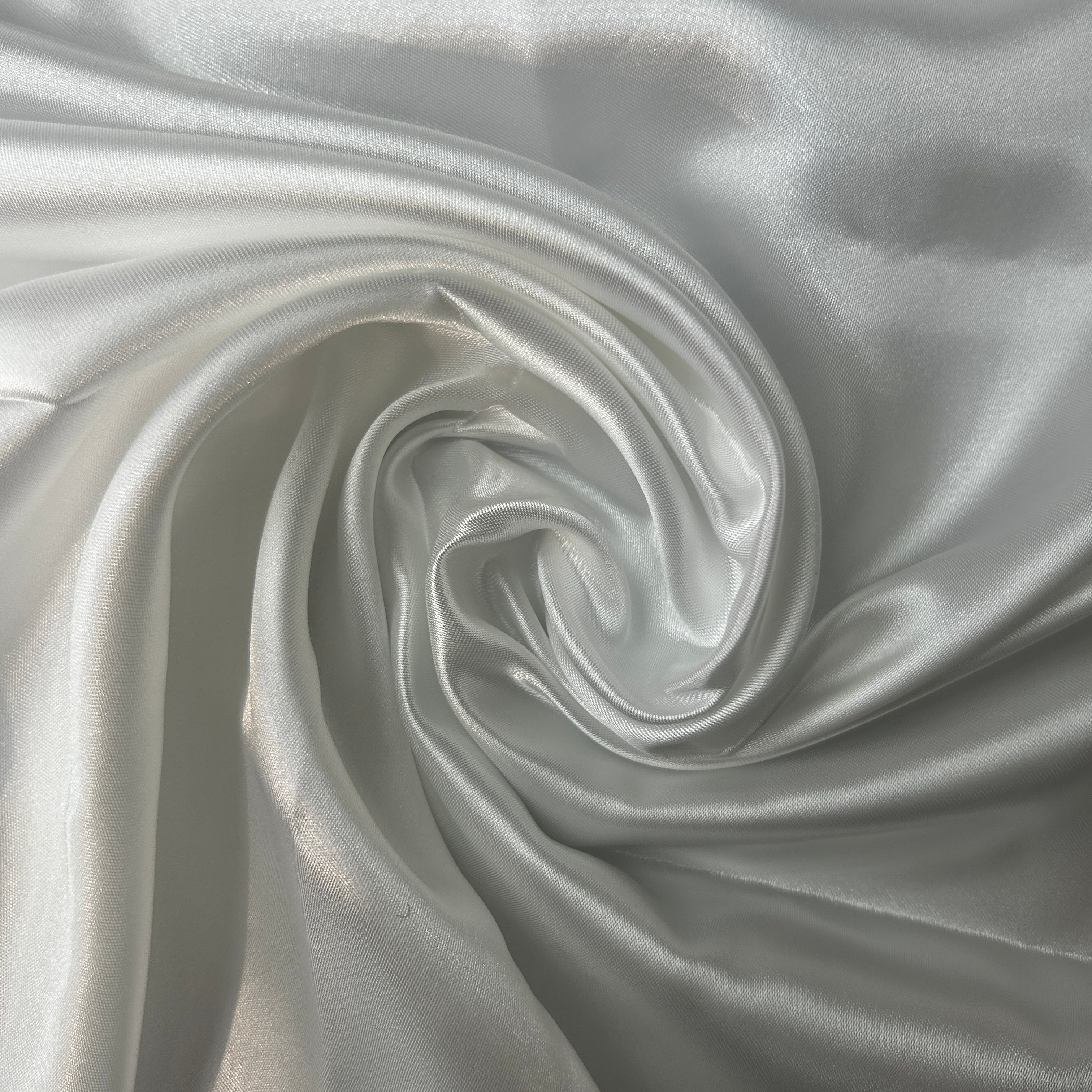 Close-up of silver fabric with a swirl pattern
