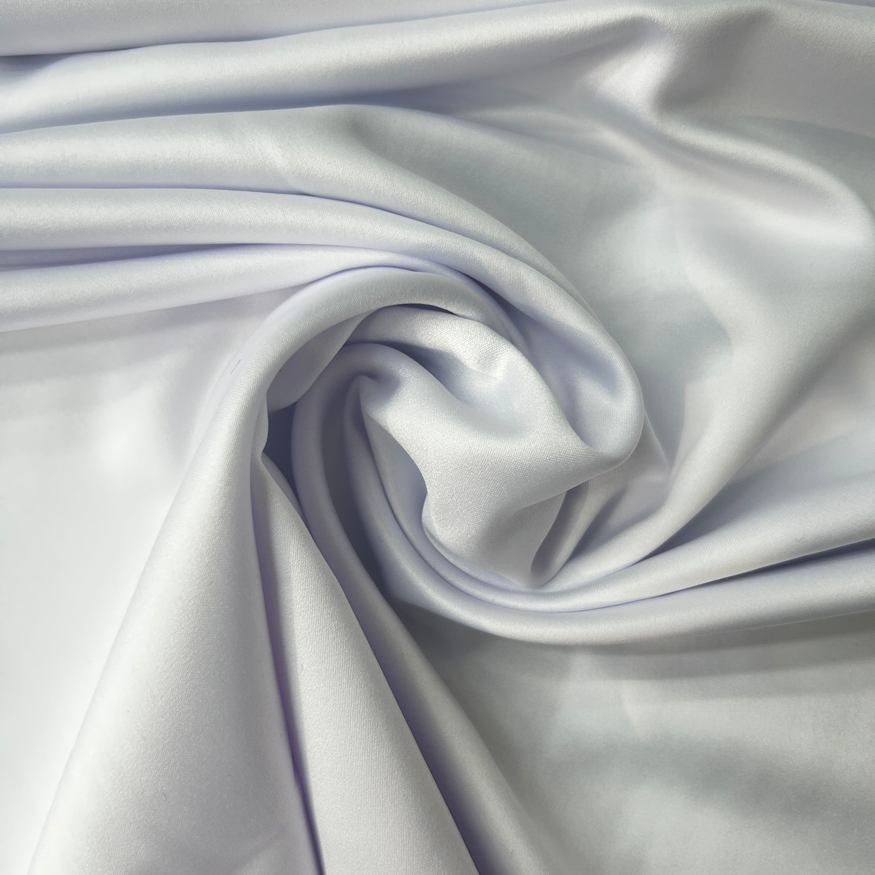 Close-up of smooth, light gray fabric with folds