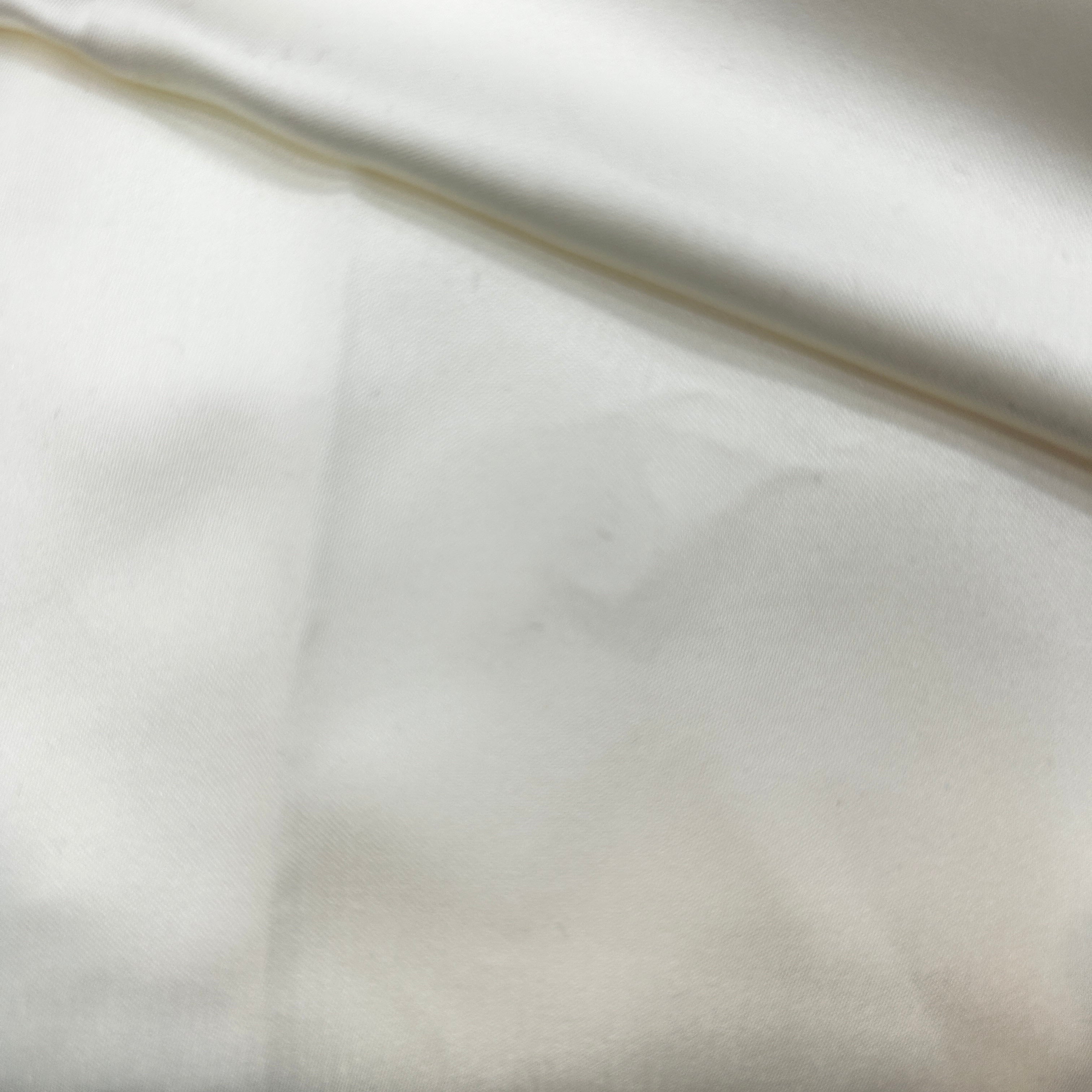 Close-up of white fabric with a subtle pattern
