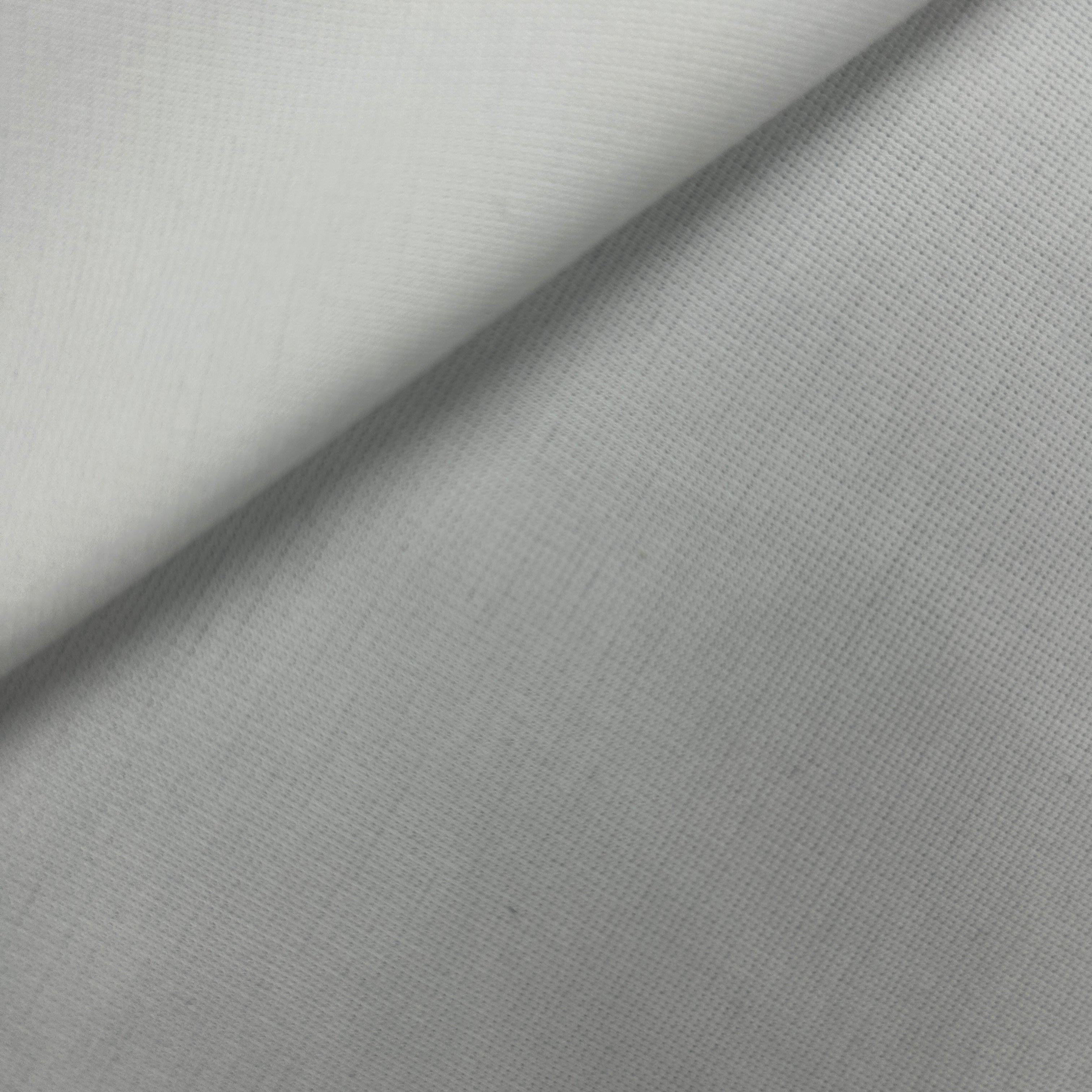 A close-up of light gray fabric with a subtle woven texture, folded diagonally to show its drape and color.