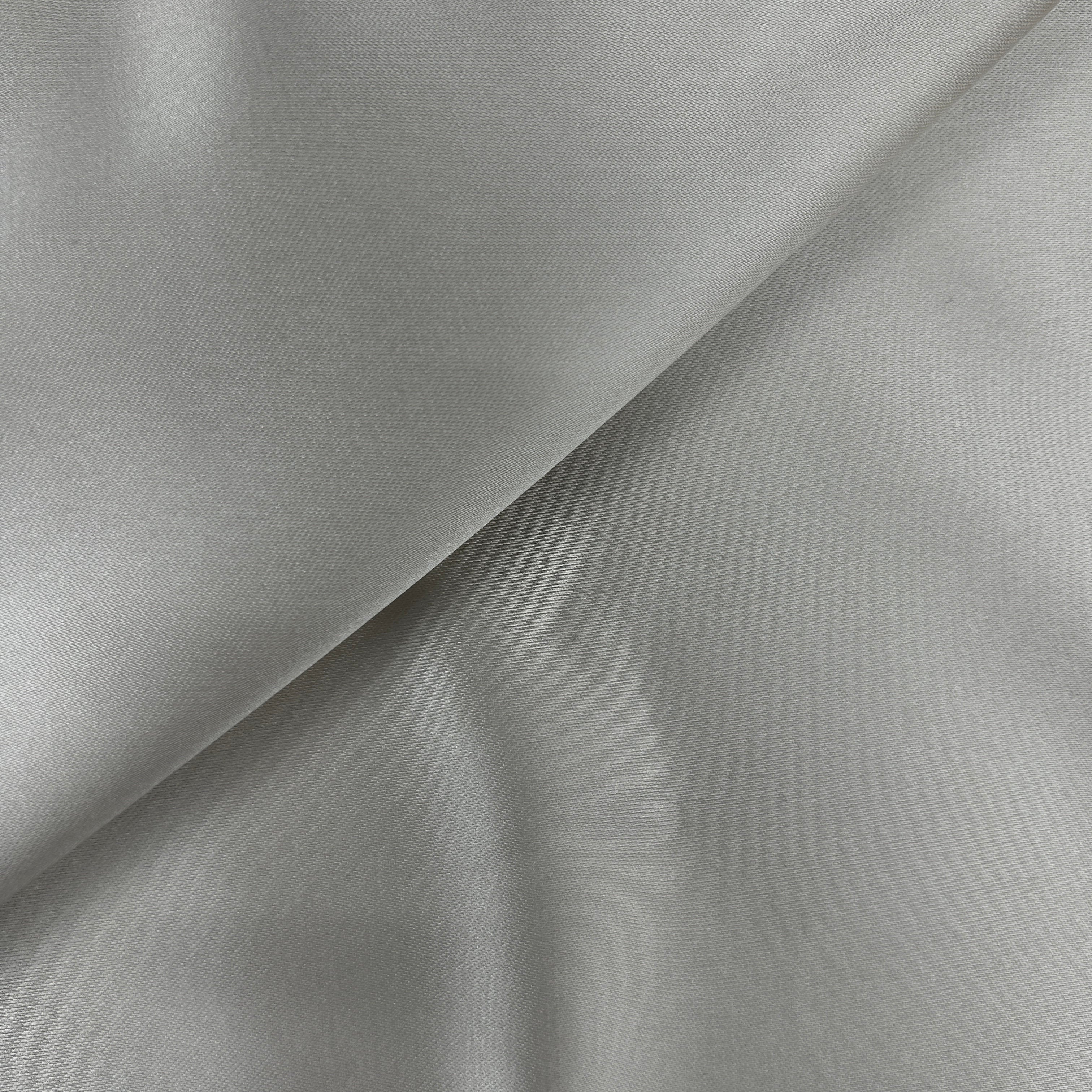 A close-up of light gray satin or silk fabric with a soft sheen and gentle folds.