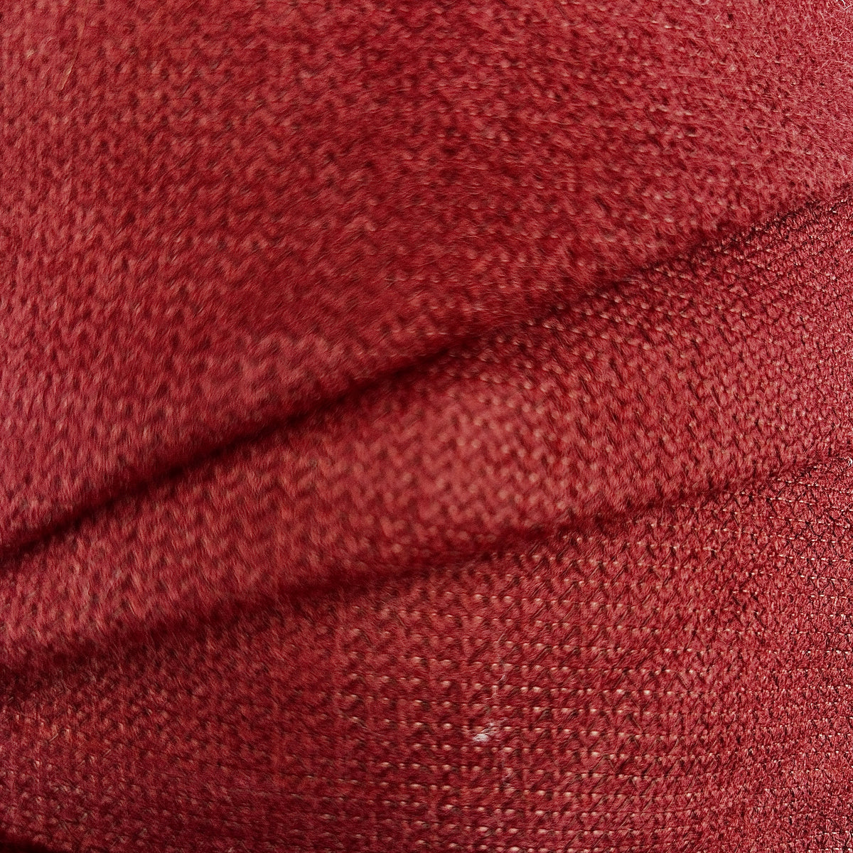 Close-up of red thick interfacing knit apparel fabric showing its textured, woven surface.