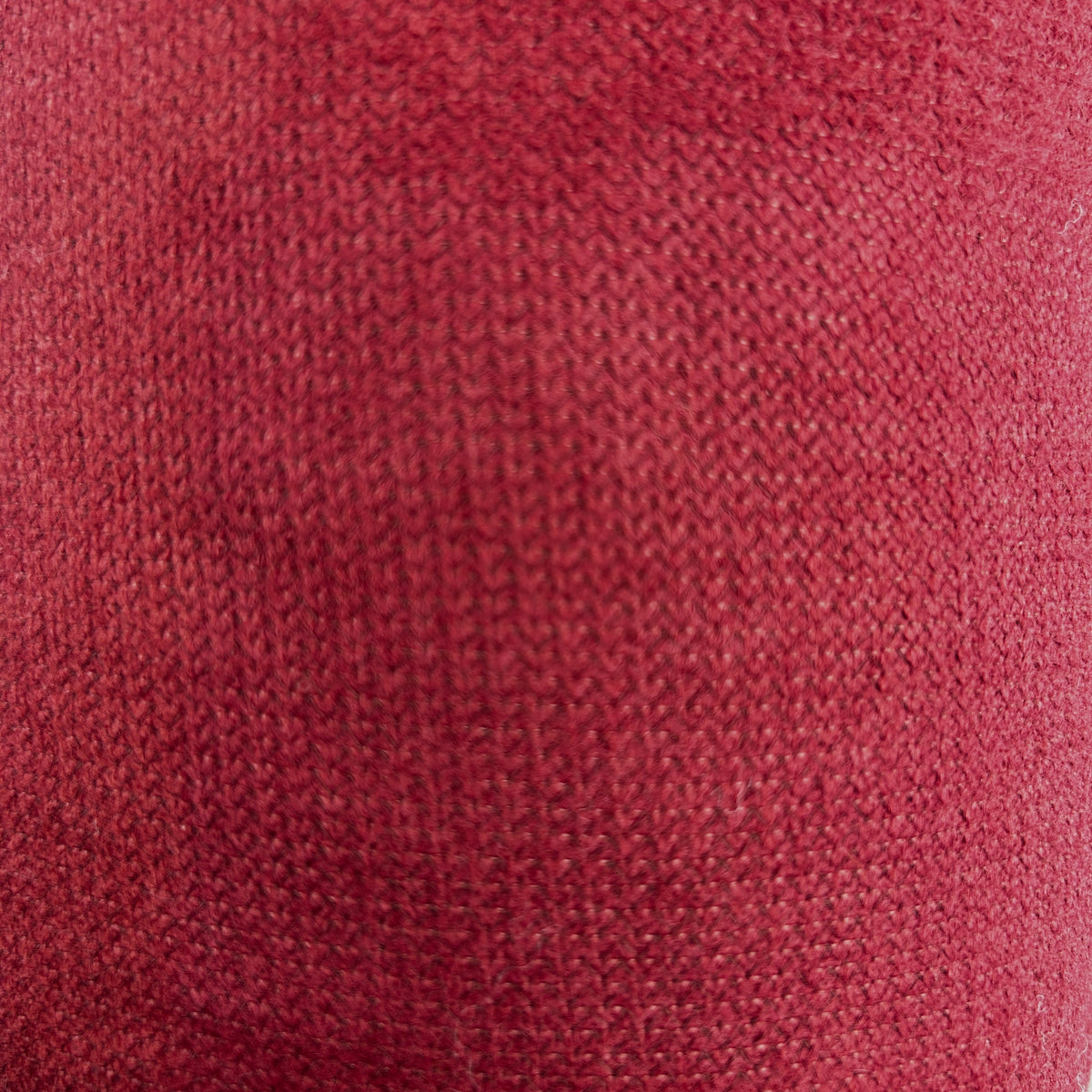 Close-up of red and green thick interfacing knit apparel fabric with a textured weave.
