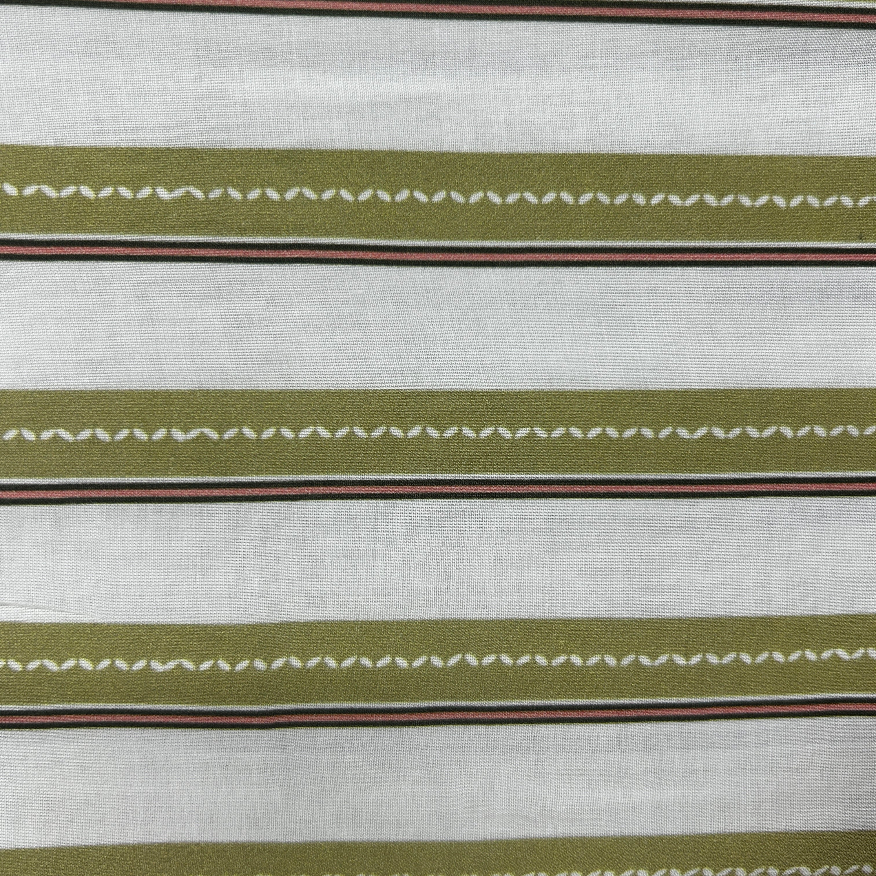 A close-up of a striped fabric pattern featuring olive green horizontal bands with white zigzag stitching details, bordered by thin red and dark brown stripes on a white textured background.