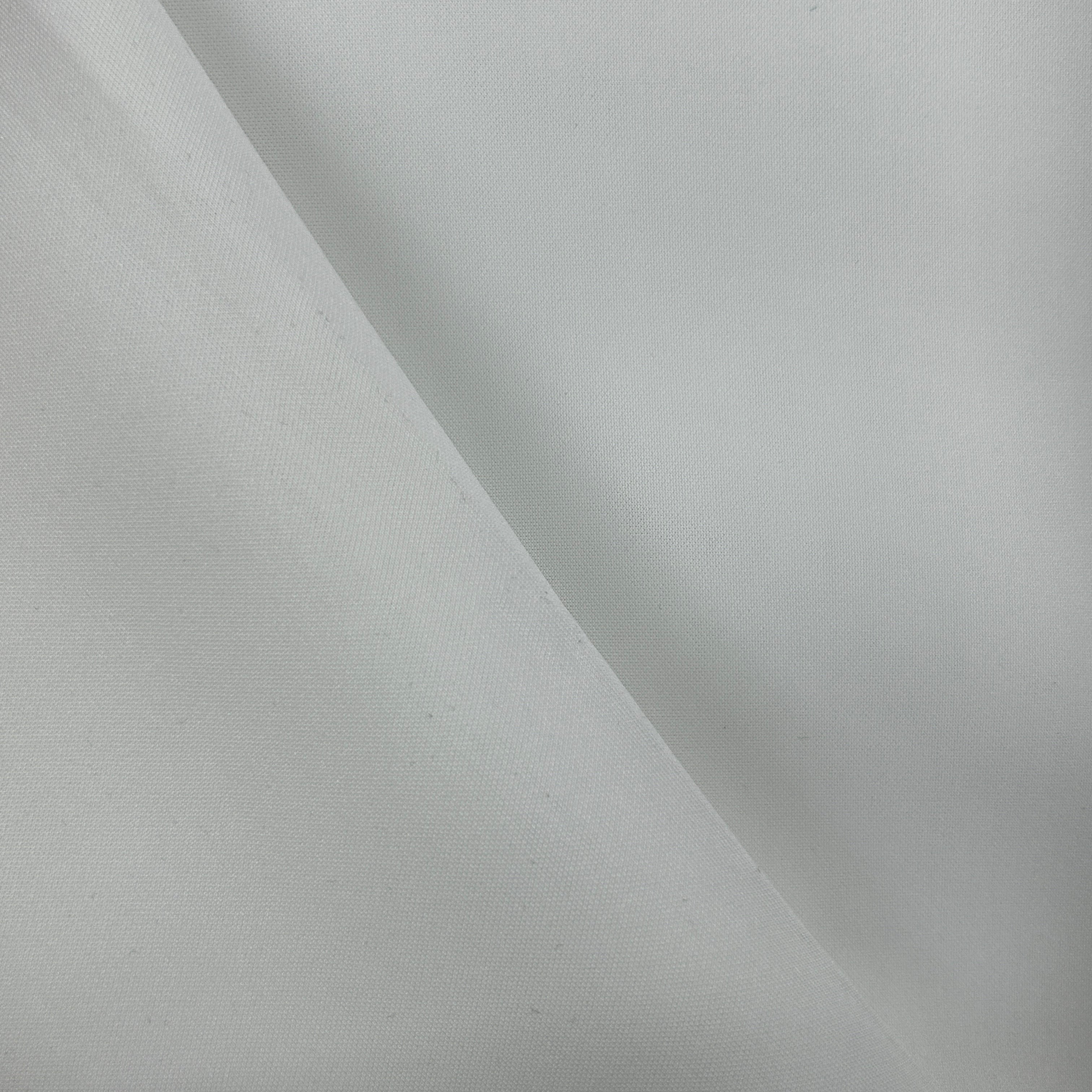 A close-up of plain white fabric with a soft diagonal fold creating a gentle shadow.