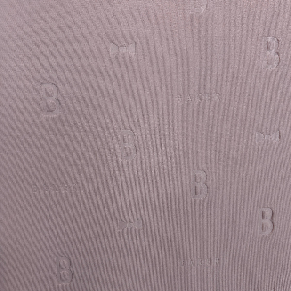 Close-up of mauve 3D Ted Baker thick scuba jersey fabric with embossed 'B', 'BAKER', and bow motifs.