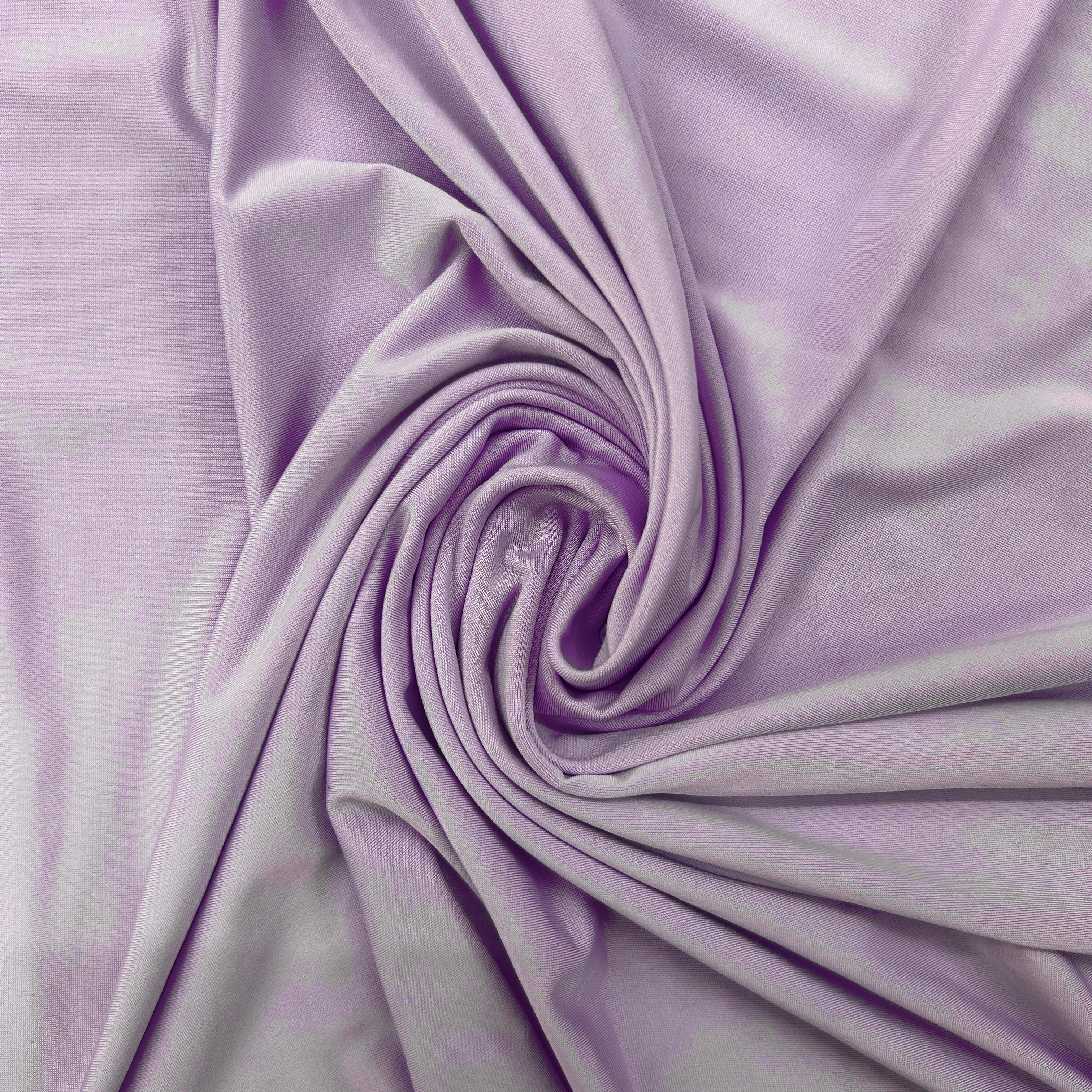 Lavender purple fabric draped in a spiral swirl pattern, showing its soft texture and smooth drape.