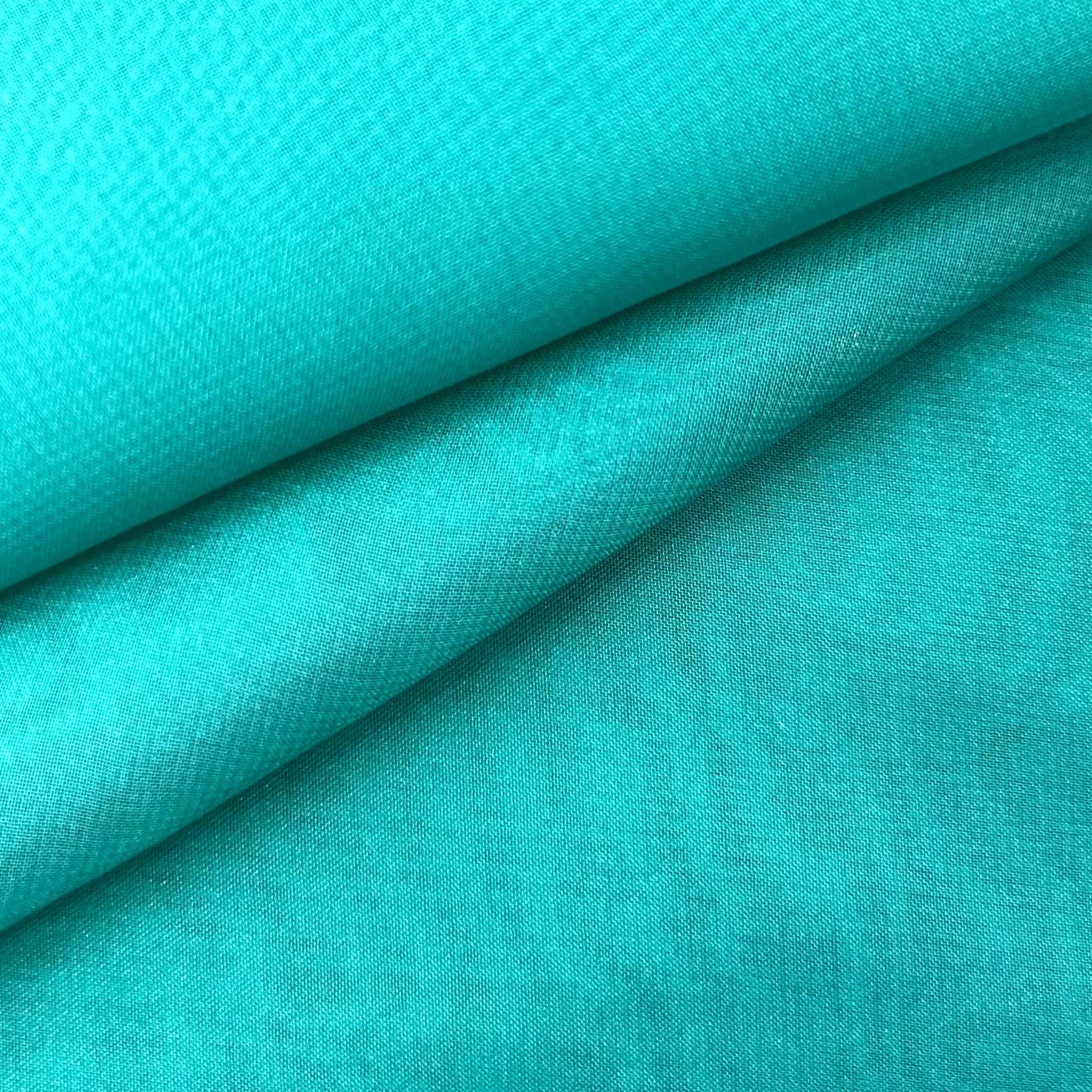 A folded piece of vibrant turquoise ultra-thin polyester chiffon fabric with a soft matte finish.