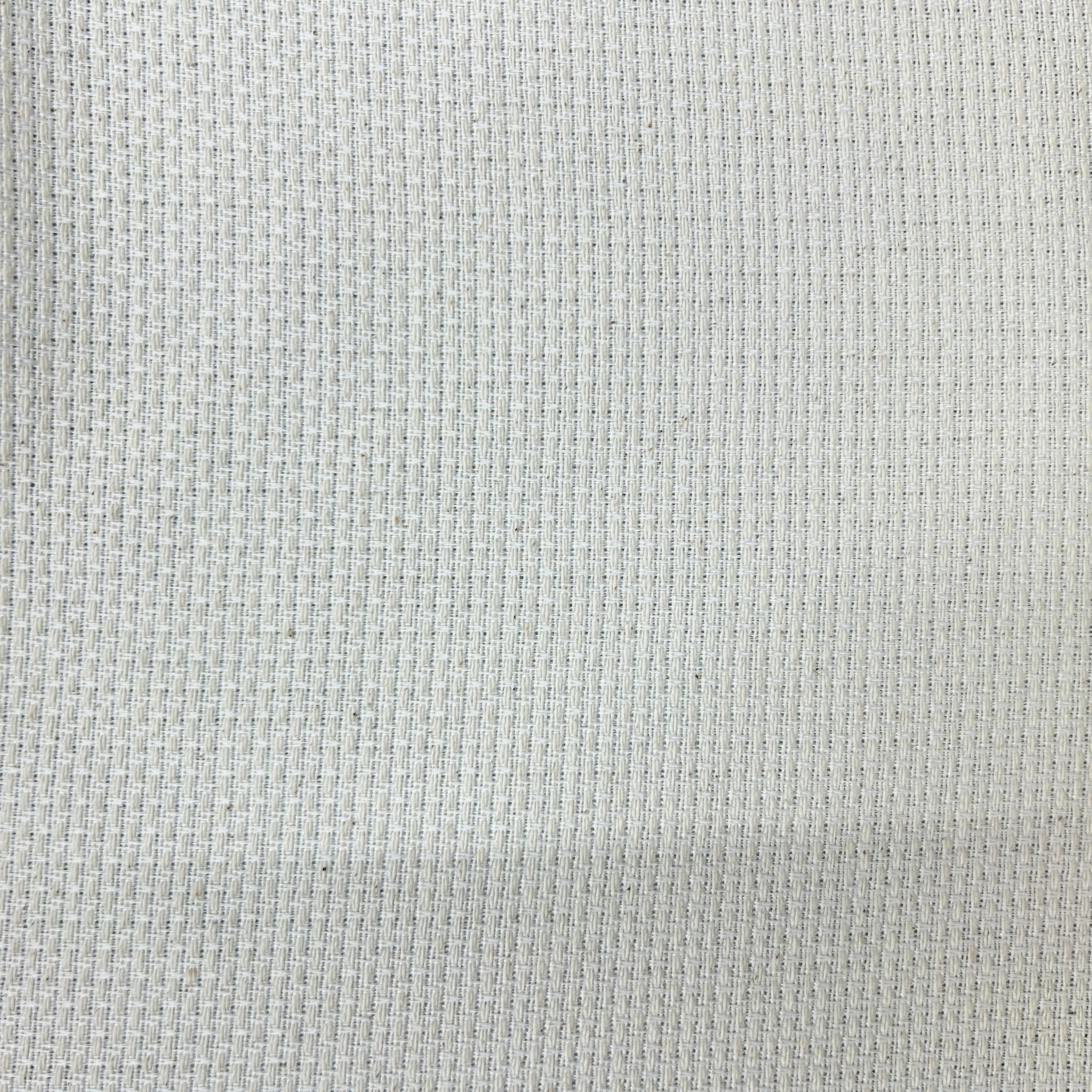 A close-up of a light gray woven fabric texture with a subtle grid pattern.