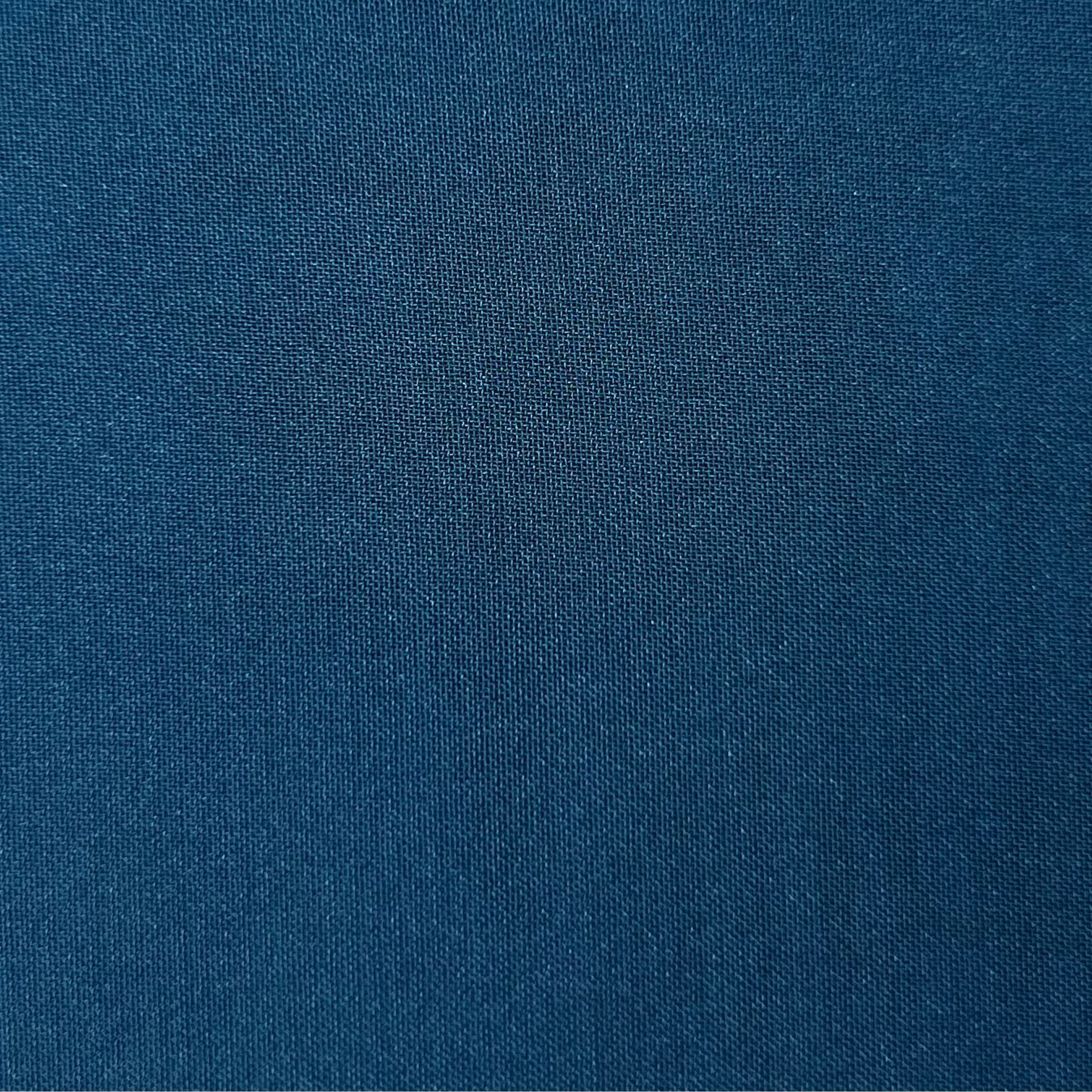A close-up view of dark blue polyester chiffon fabric with a fine, matte, and textured weave.