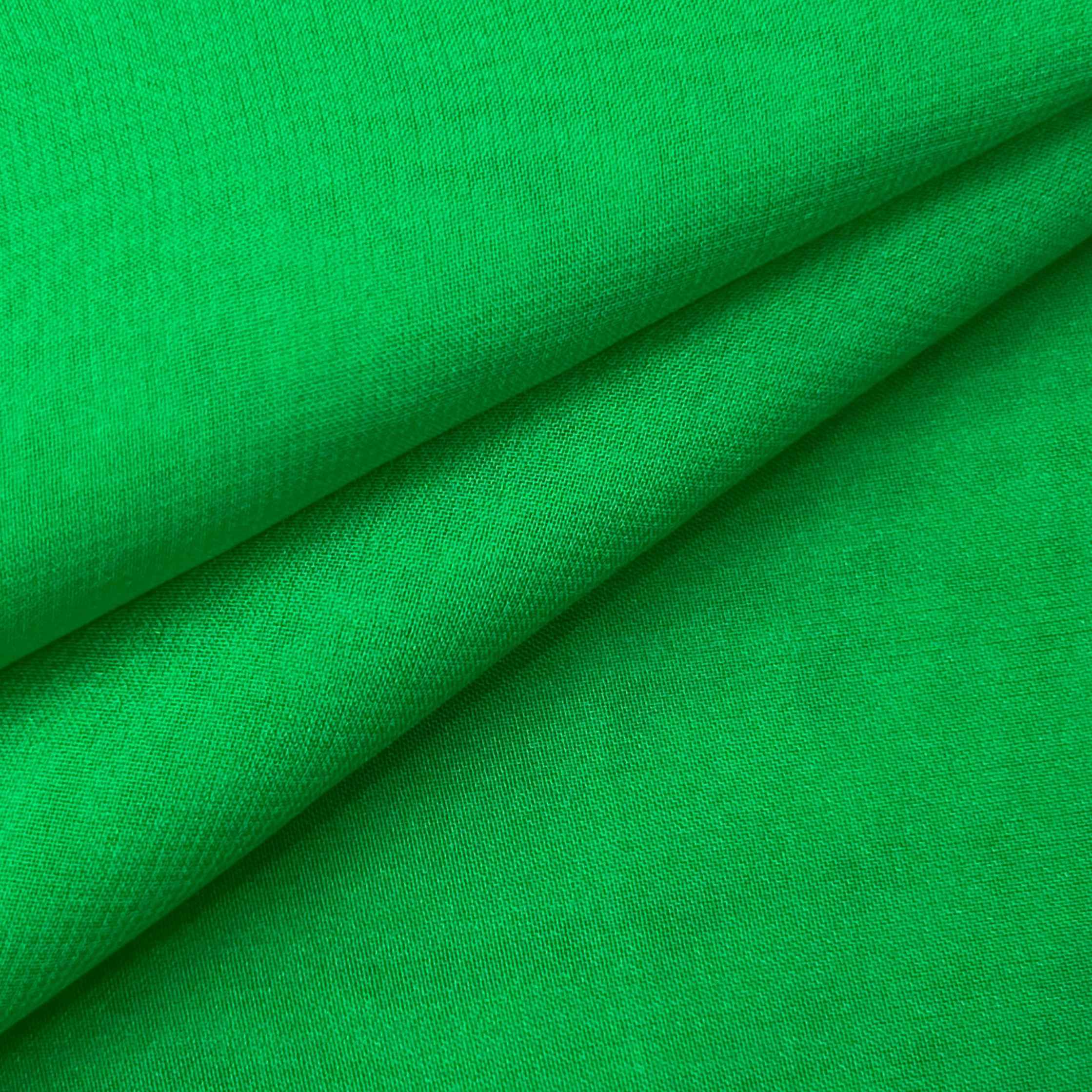 High quality ultra thin polyester chiffon fabric in a vibrant bright green color.
