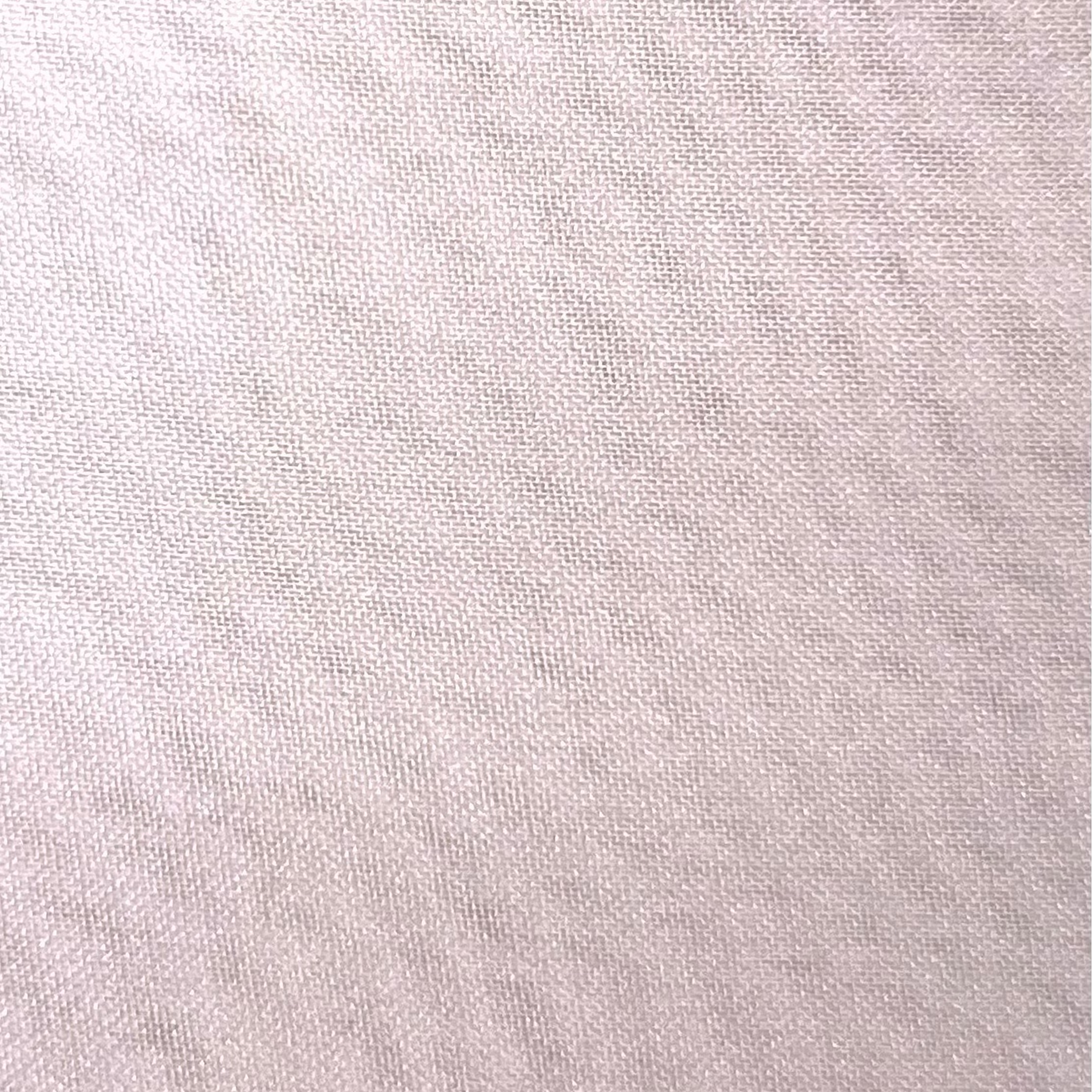 Close-up of high quality ultra thin polyester chiffon fabric in a soft lavender pink hue.