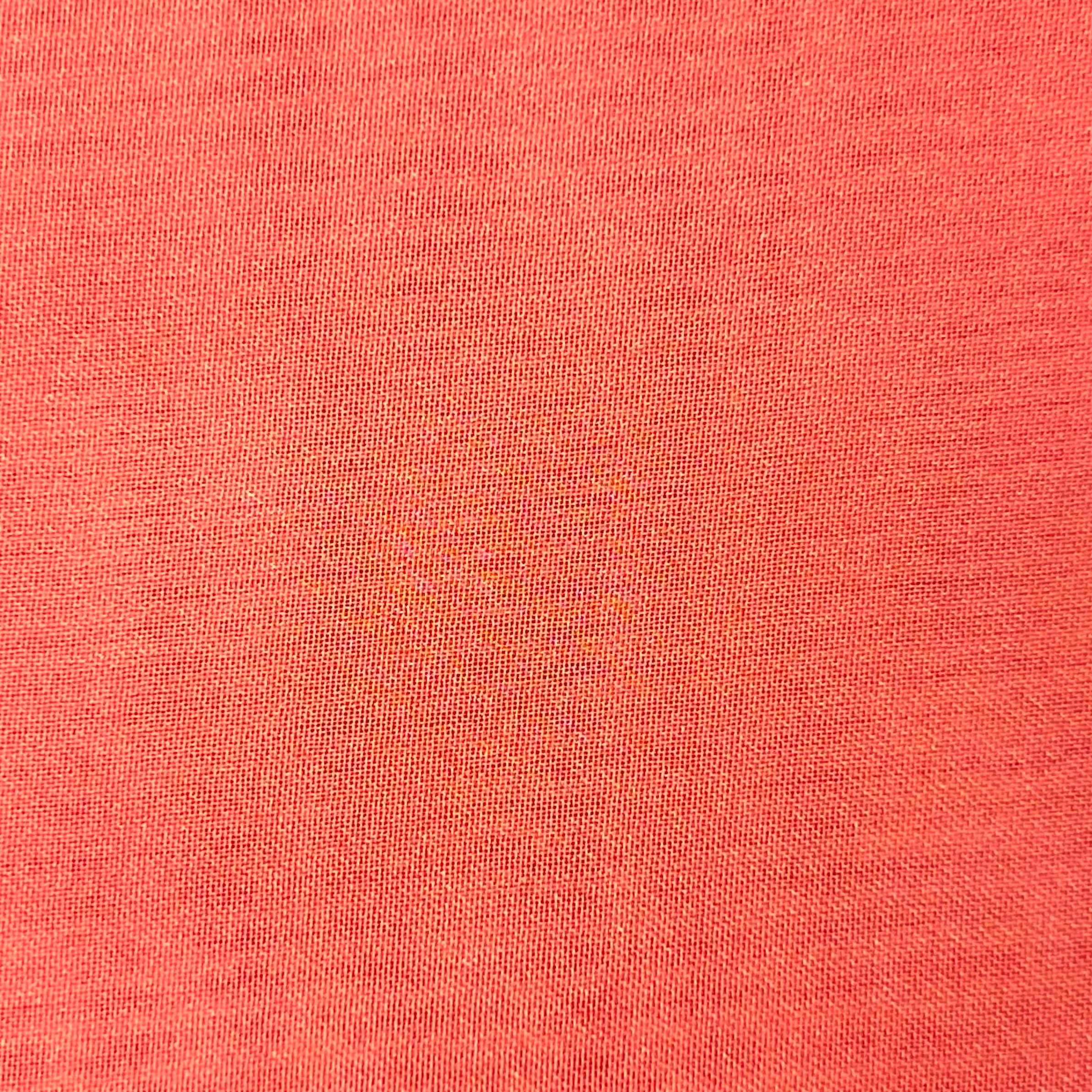 Close-up of high-quality ultra-thin polyester chiffon fabric in a vibrant coral orange color.