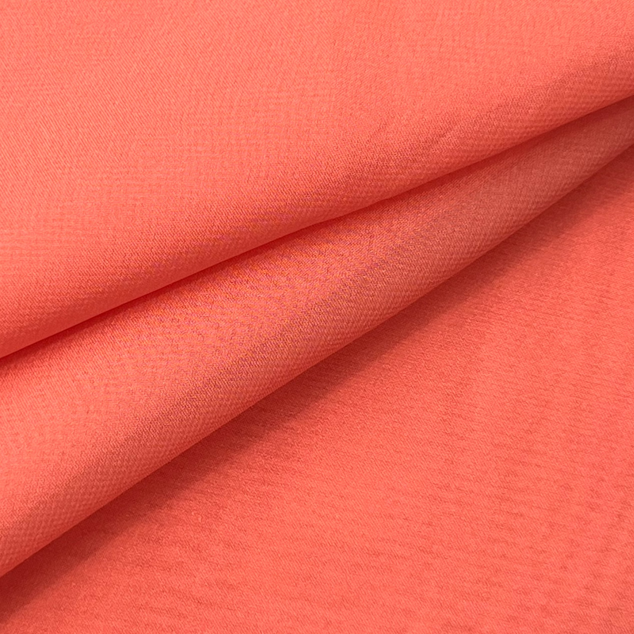 High quality ultra thin polyester chiffon fabric in a vibrant coral orange color.
