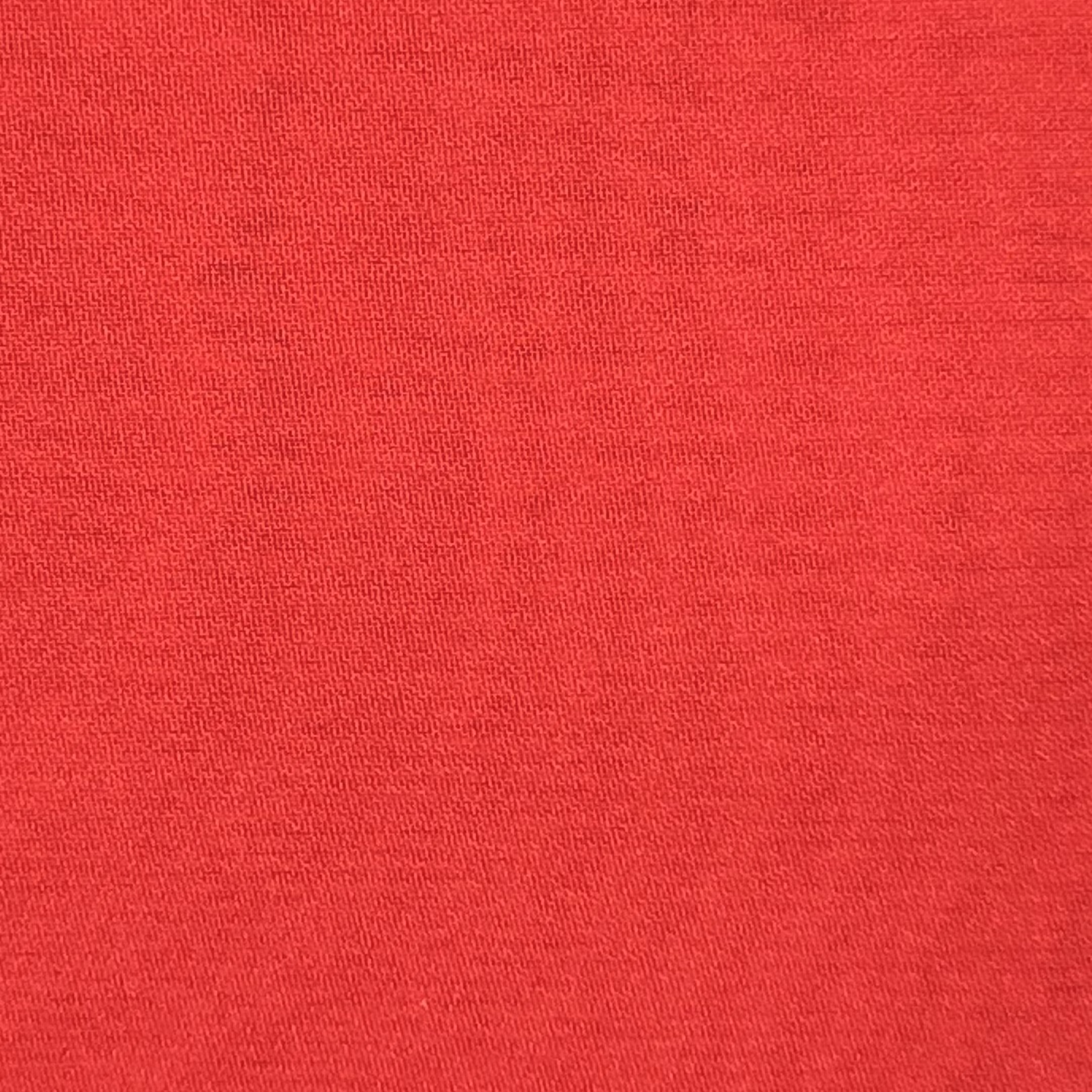 Close-up of high-quality, ultra-thin red polyester chiffon fabric with a fine, textured weave.