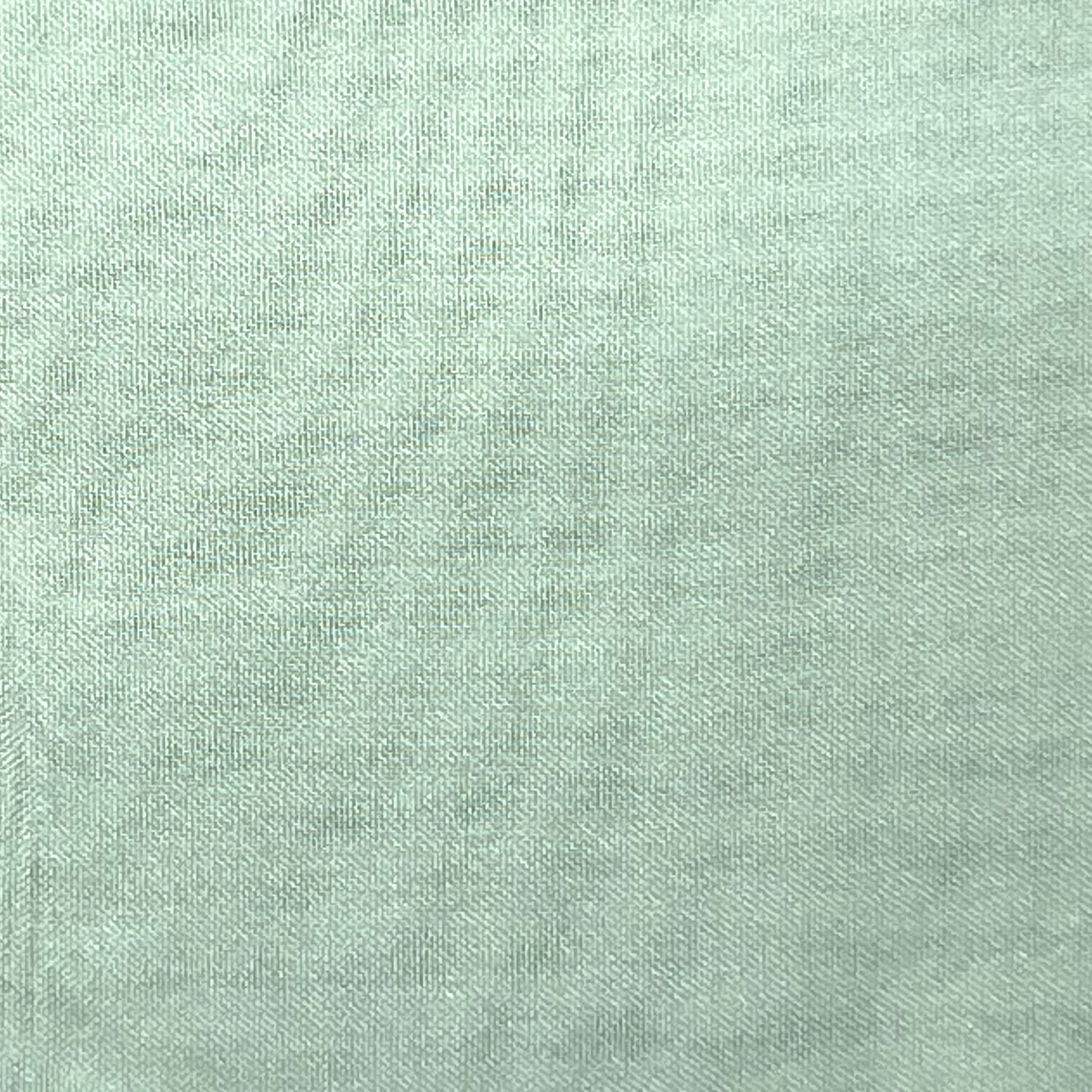Close-up of high-quality ultra-thin polyester chiffon fabric in a light mint green color.