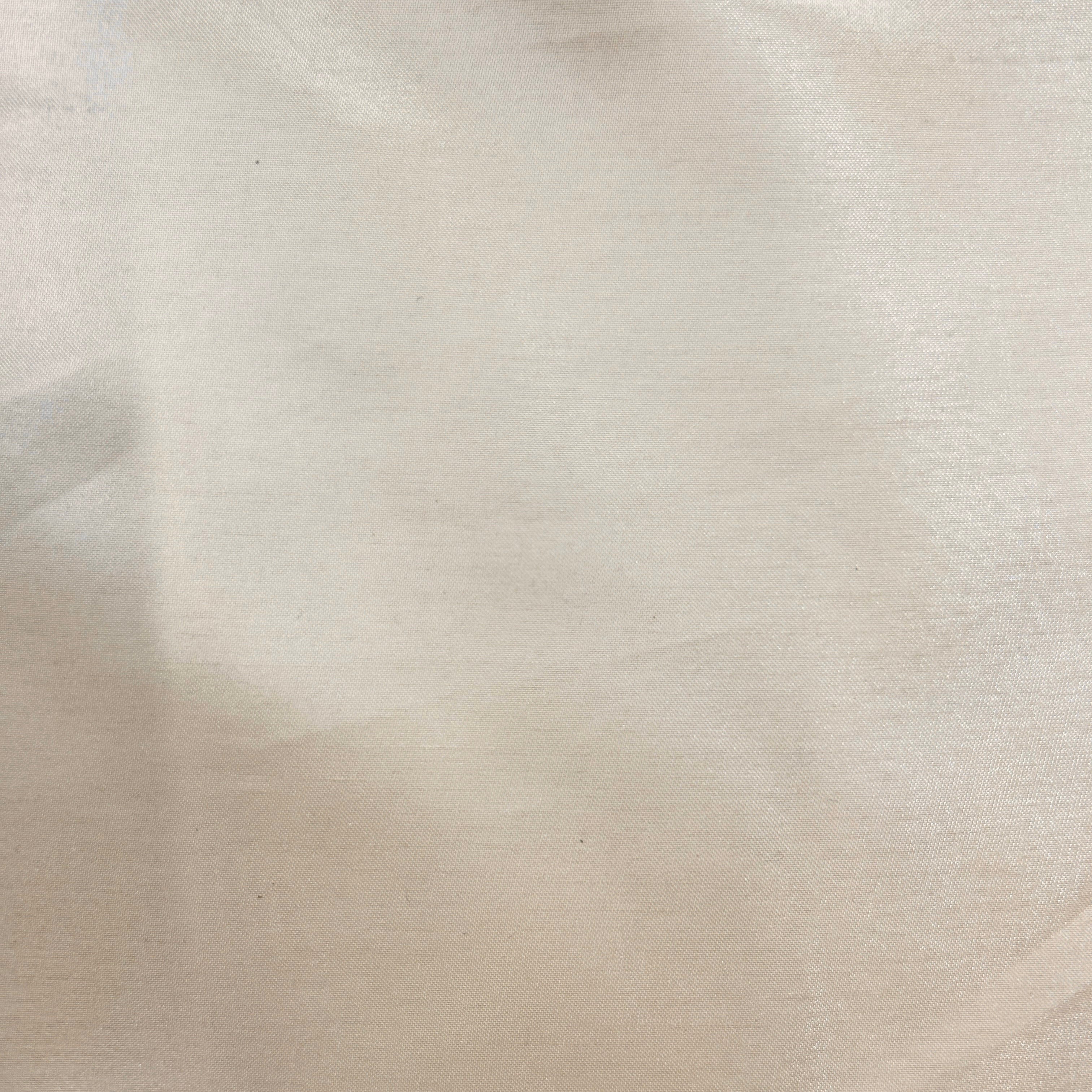 A close-up of a light beige or cream-colored fabric with a soft, slightly sheer texture.