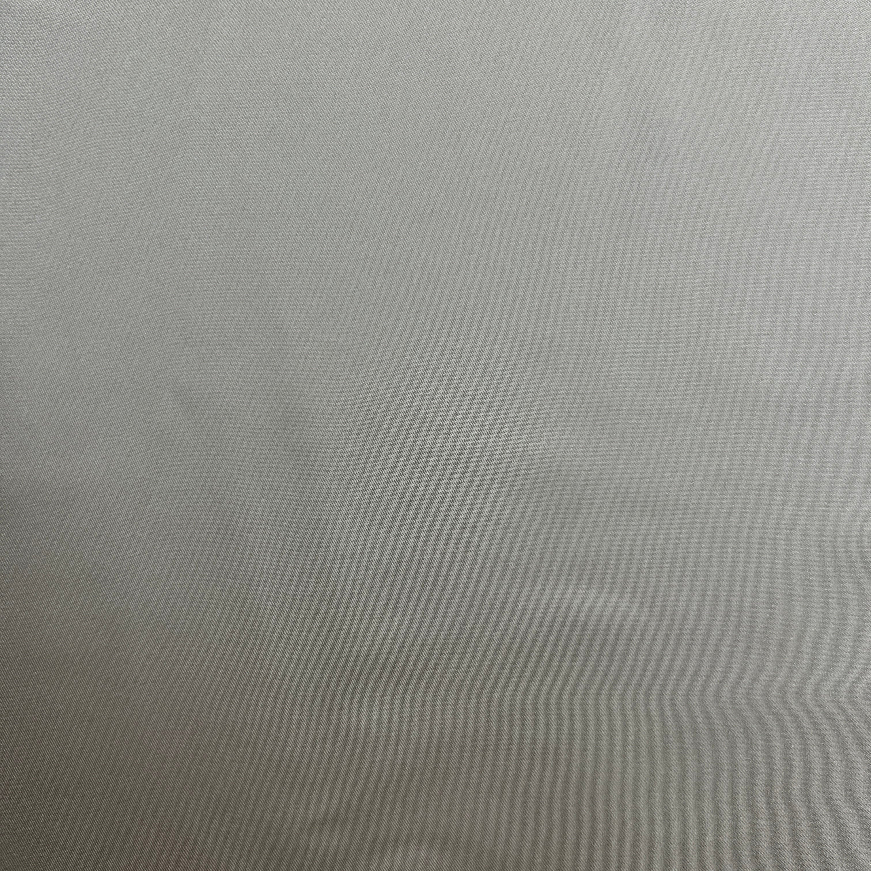 A close-up of a light gray textured surface, likely a fabric swatch or material sample.