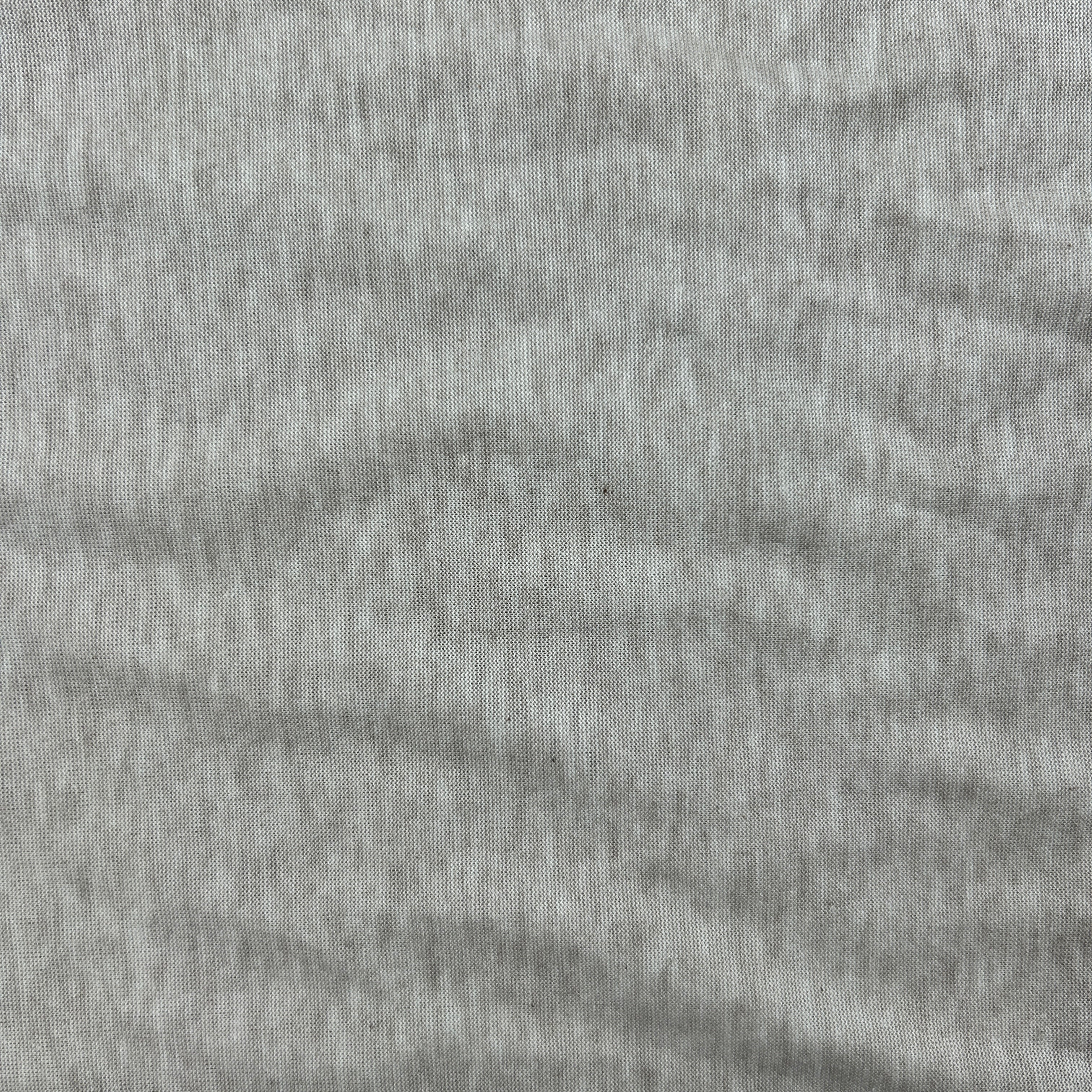 A close-up of light gray heathered fabric with a fine ribbed texture and soft folds.