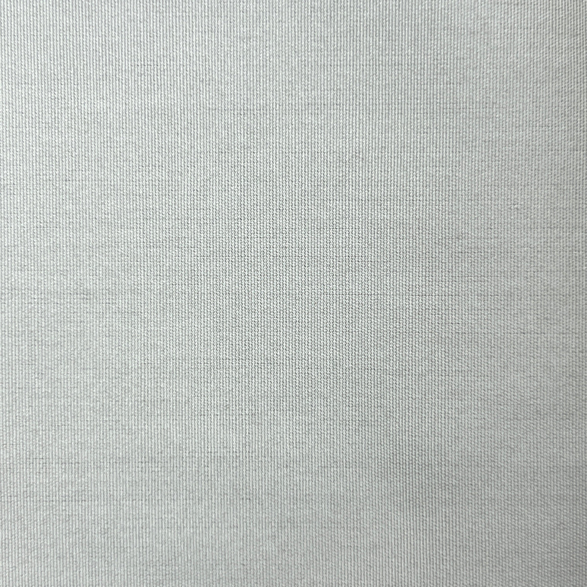 A close-up of a light gray textured fabric, showing a fine woven pattern.