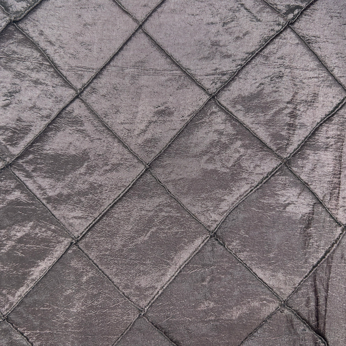 Close-up of purple quilt style upholstery fabric with a diamond-stitched textured pattern.