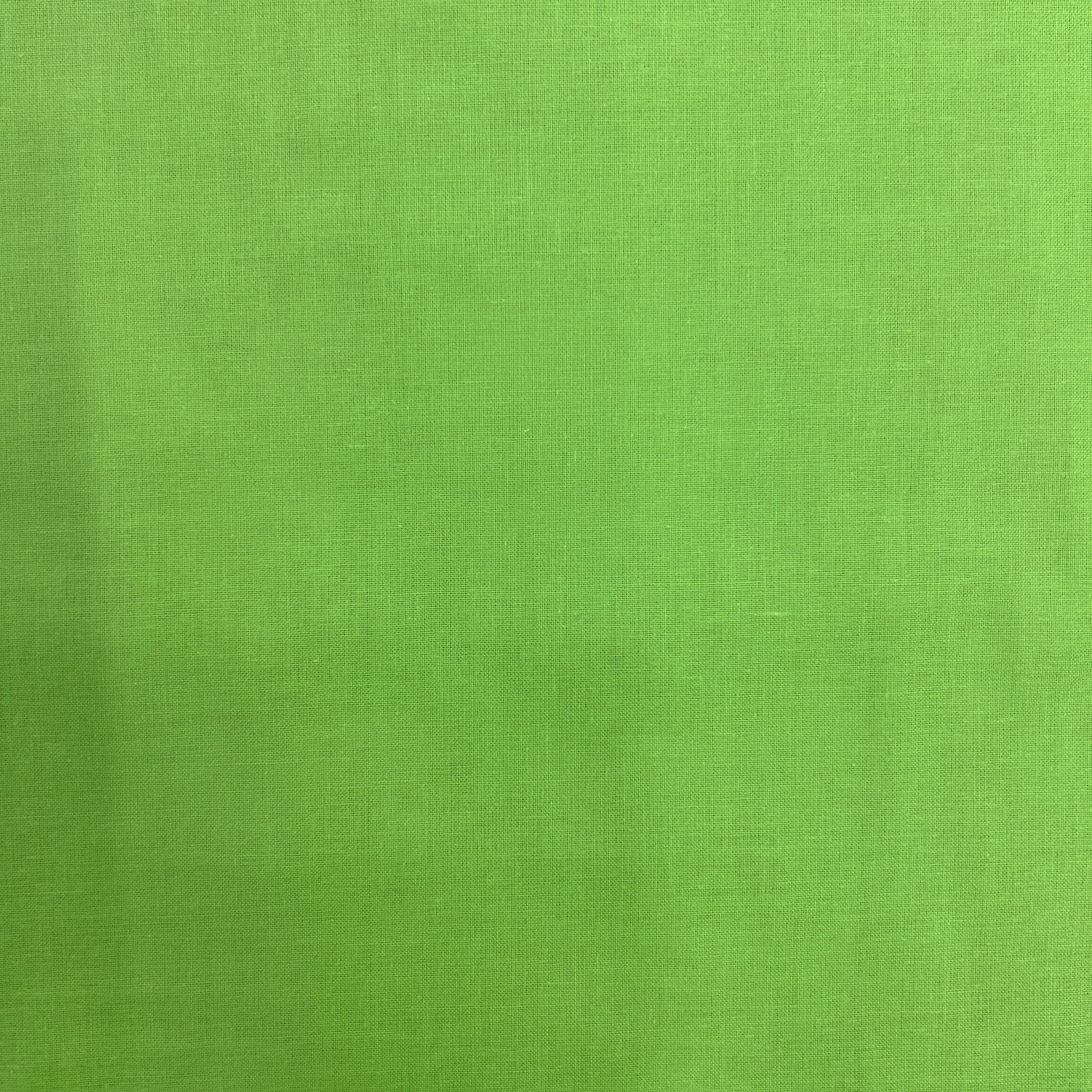 A close-up of a bright lime green textured fabric, showing a fine woven pattern.