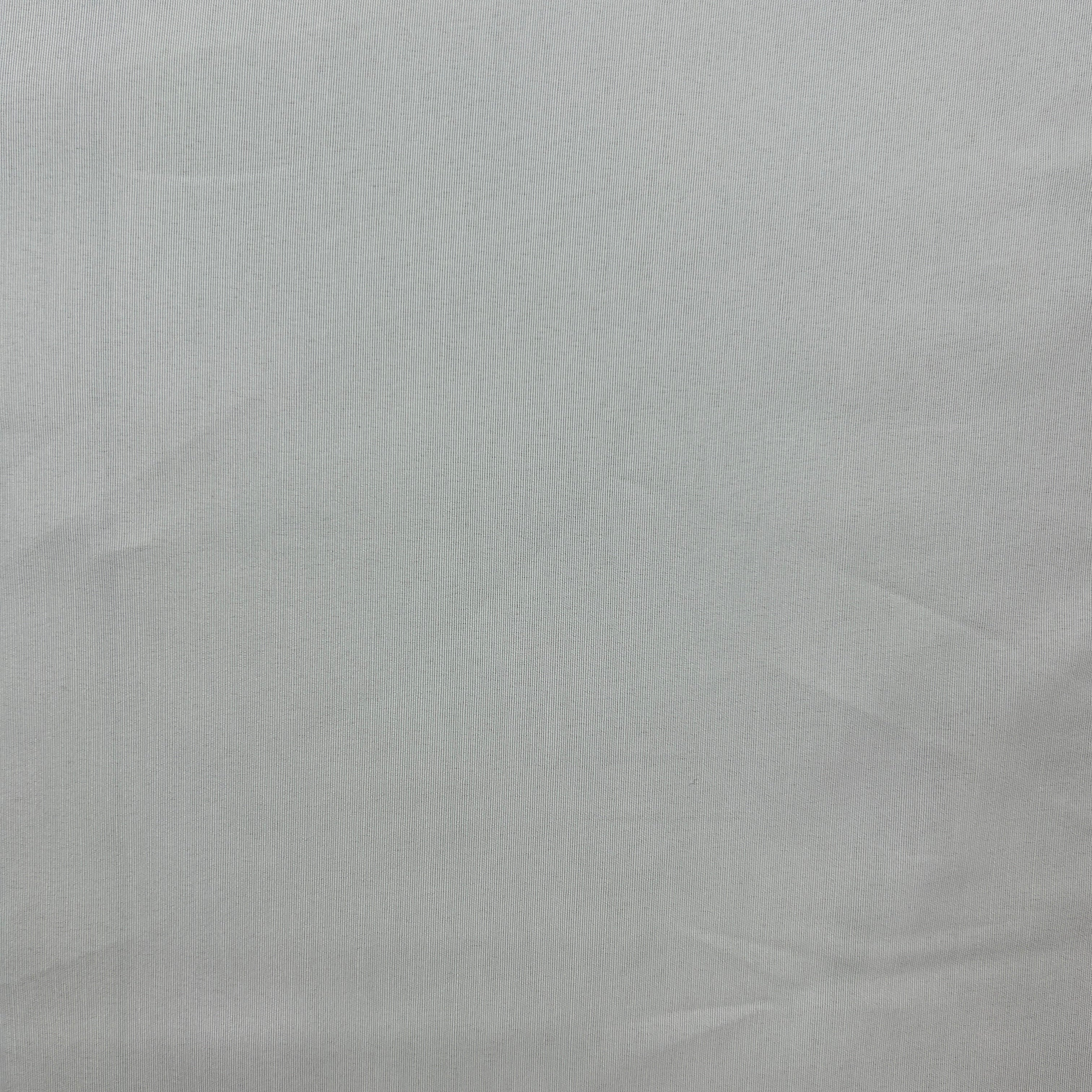 A close-up of a light gray fabric texture with subtle folds and creases.