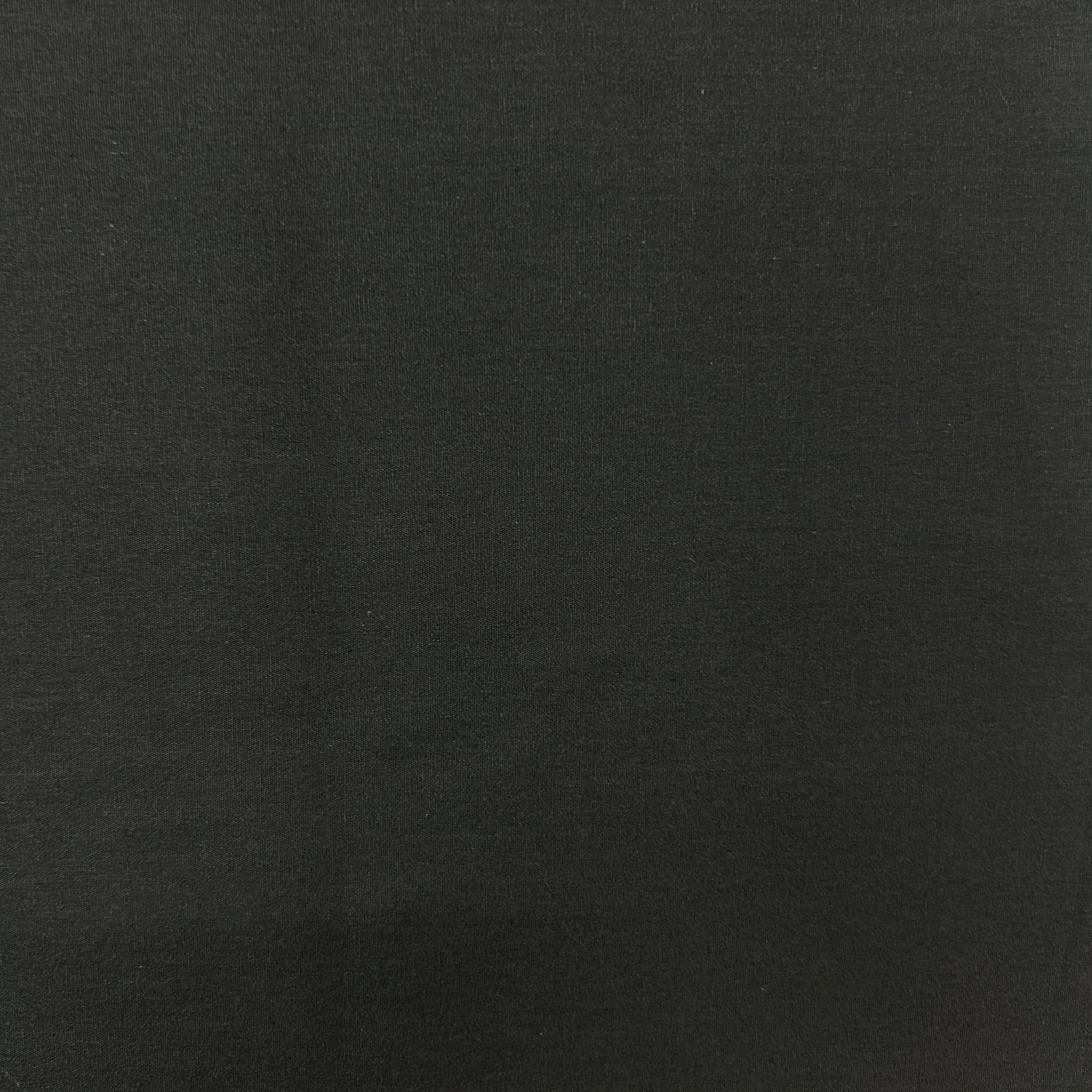 A close-up of a solid black textured fabric surface.