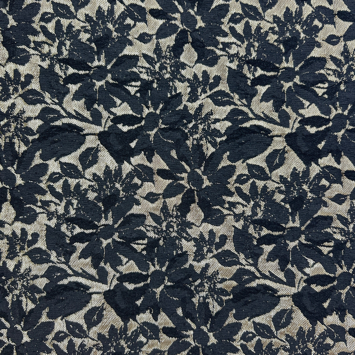 Green and black floral brocade upholstery fabric with an intricate woven leaf and flower pattern.