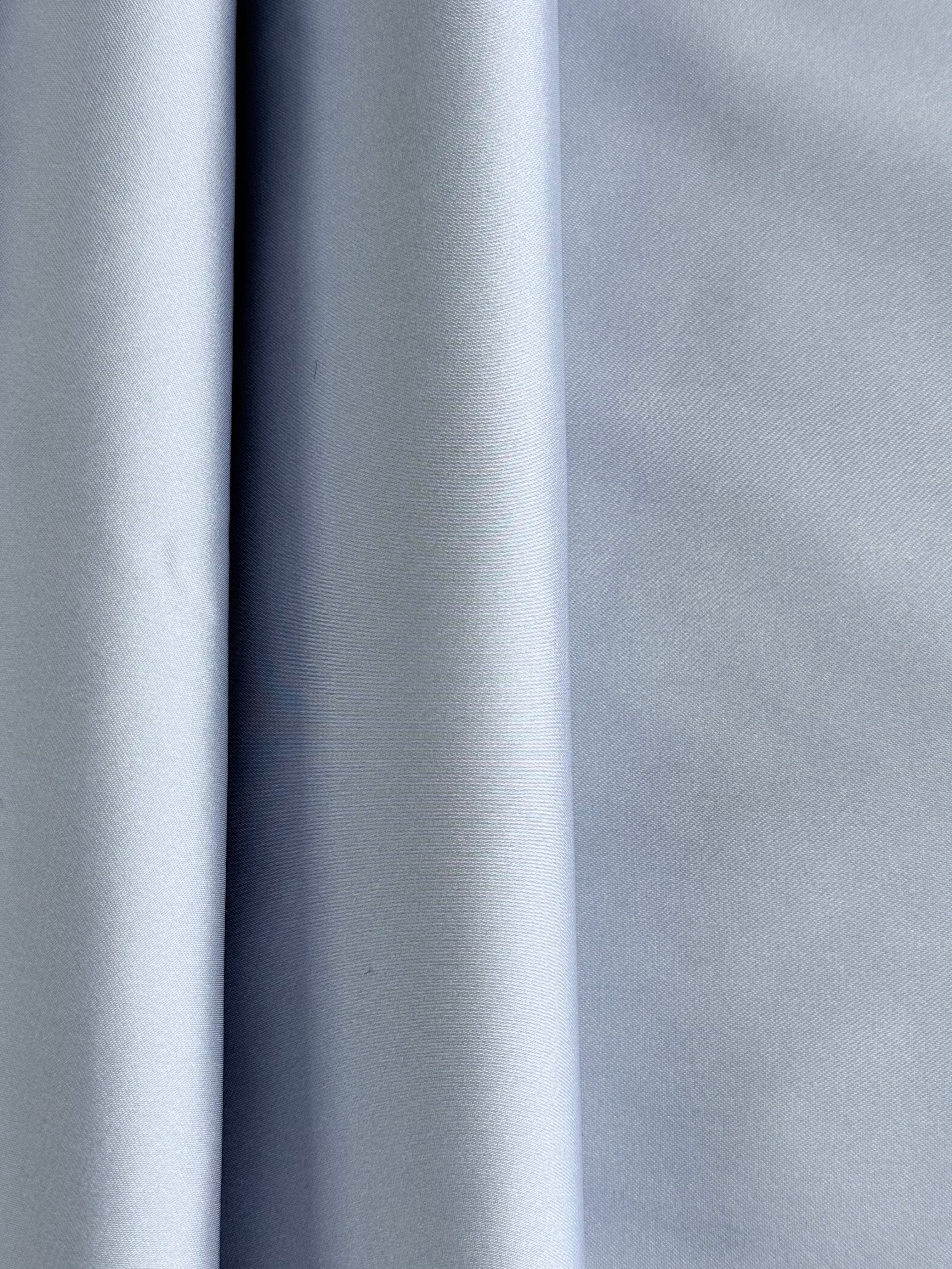 Lilac bonded satin polyester fabric with a smooth, lustrous finish and structured drape.