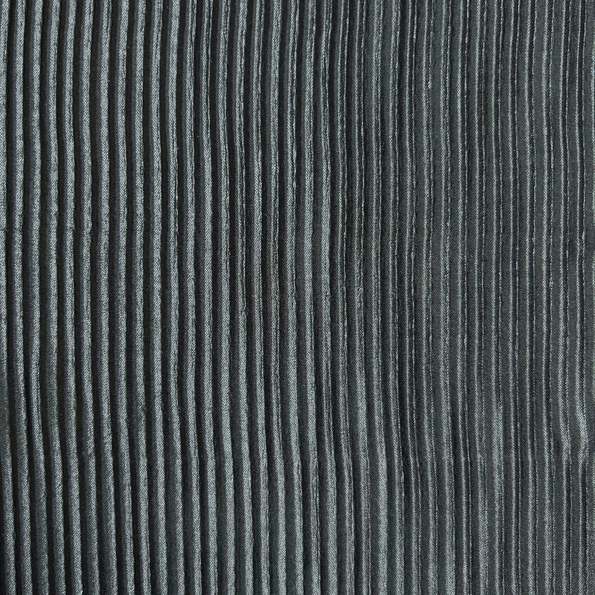 Close-up of a dark gray ribbed corduroy fabric texture with vertical ridges.