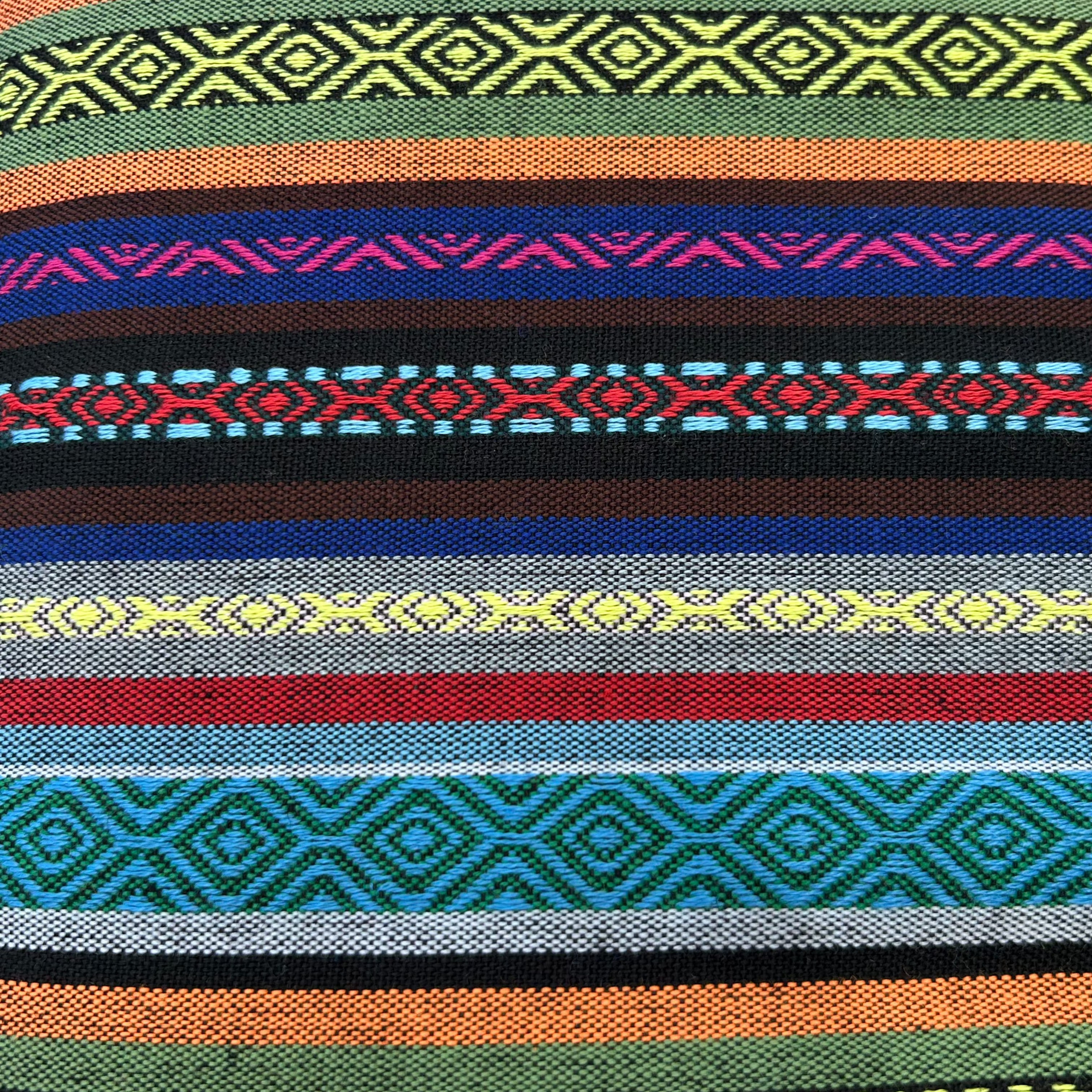 Close-up view of jacquard striped polyester fabric with intricate woven-in stripe patterns in multicolour pink and blue.