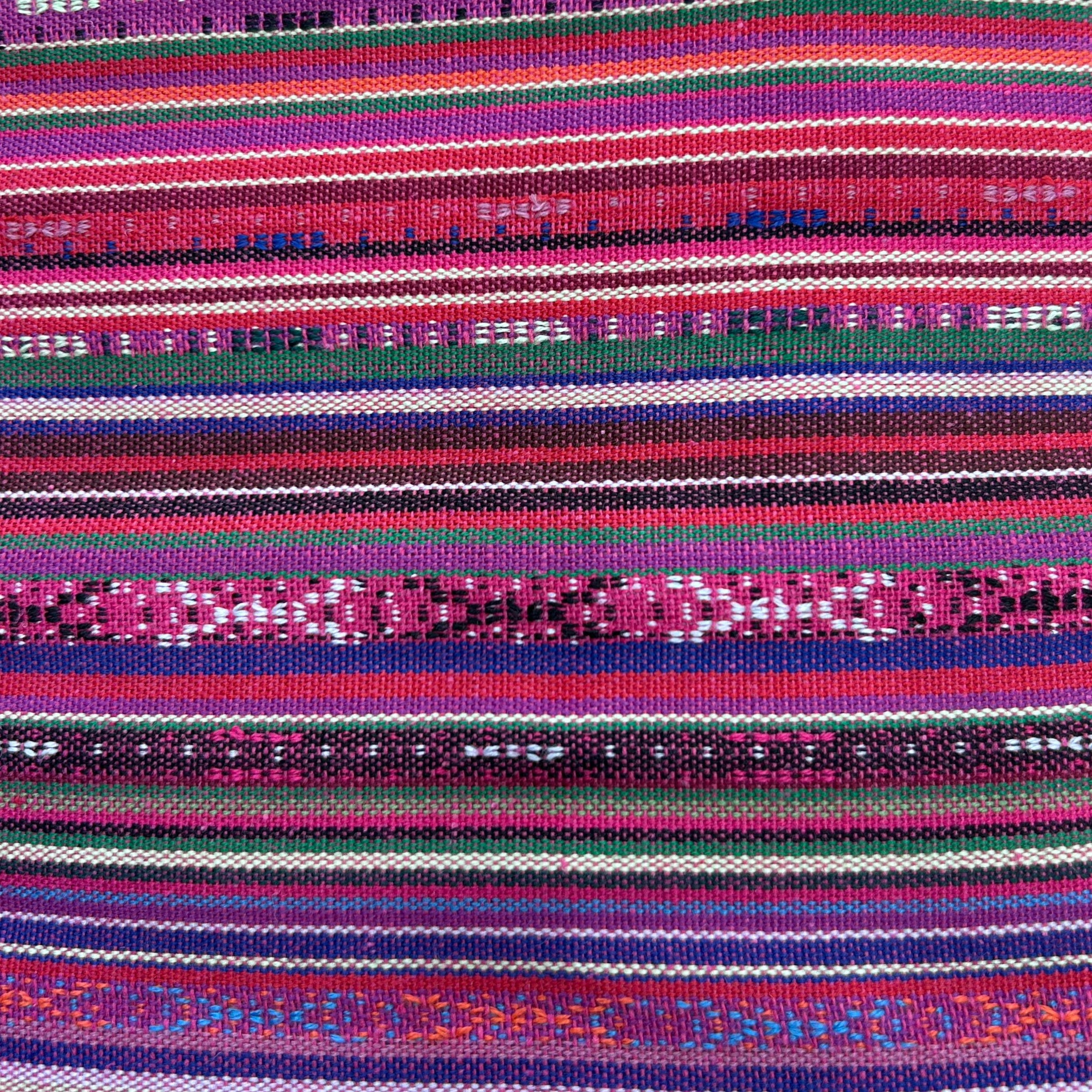 Close-up view of jacquard striped polyester fabric with intricate woven-in stripe patterns in multicolour pink and blue.