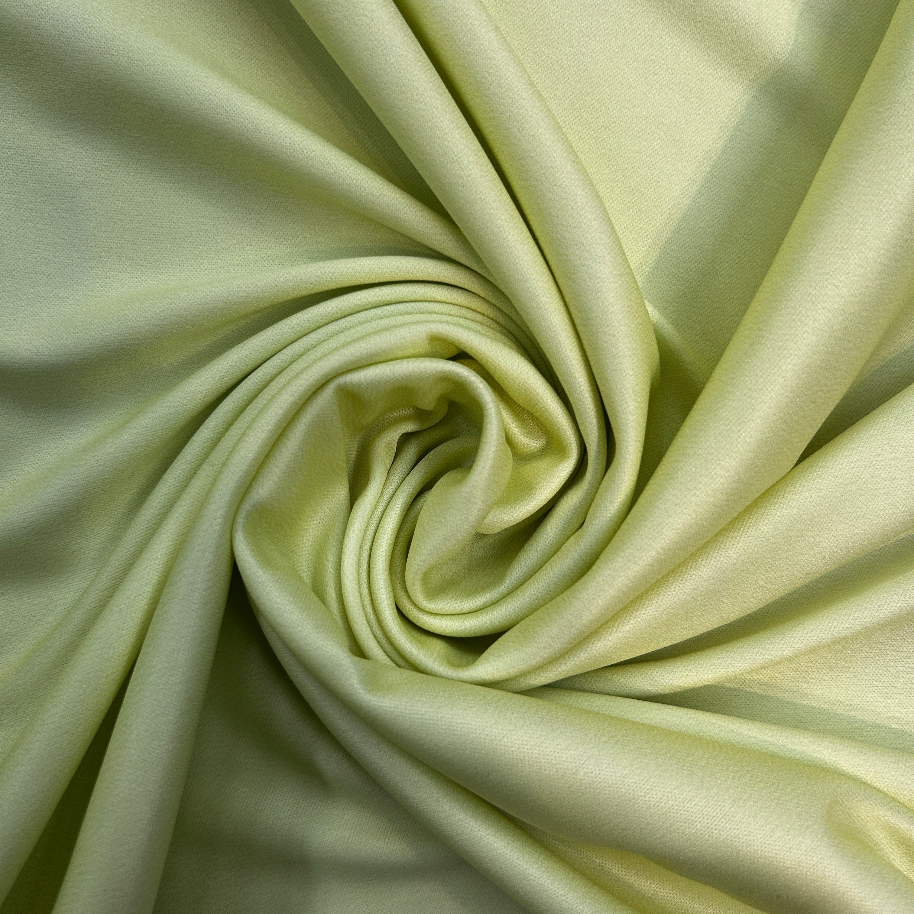 Close-up of light green fabric with a swirl pattern