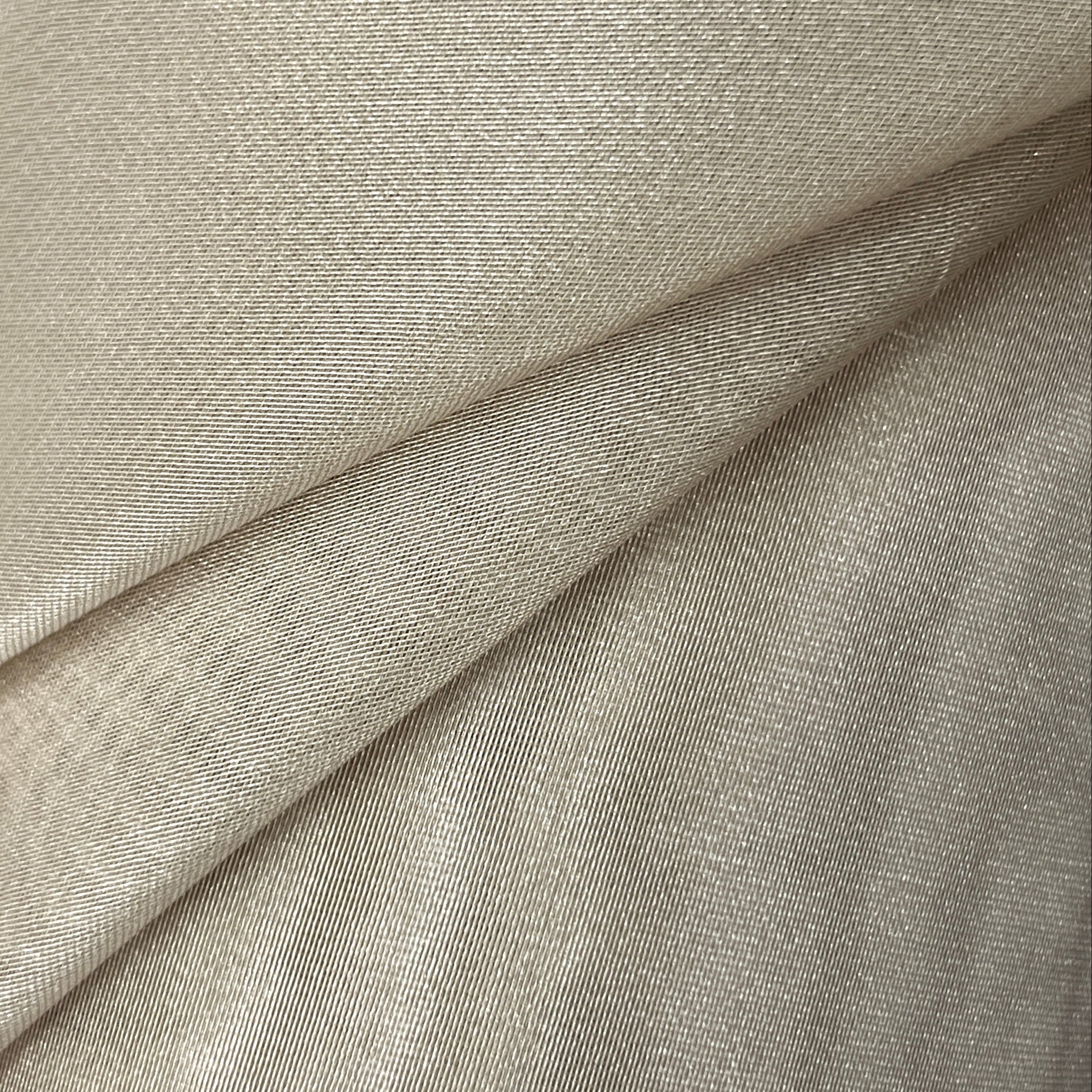 Close-up of beige fabric with a subtle pattern