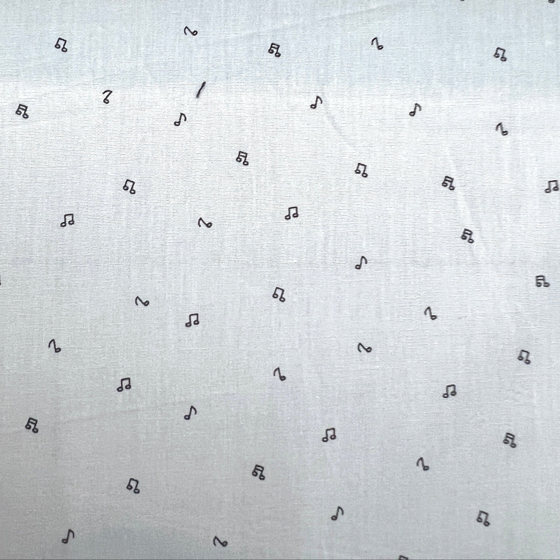 Pattern of black musical notes on a light gray background