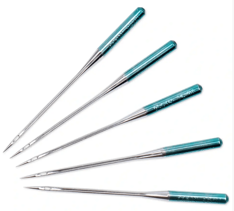 Five silver steel quilting sewing machine needles with teal handles.